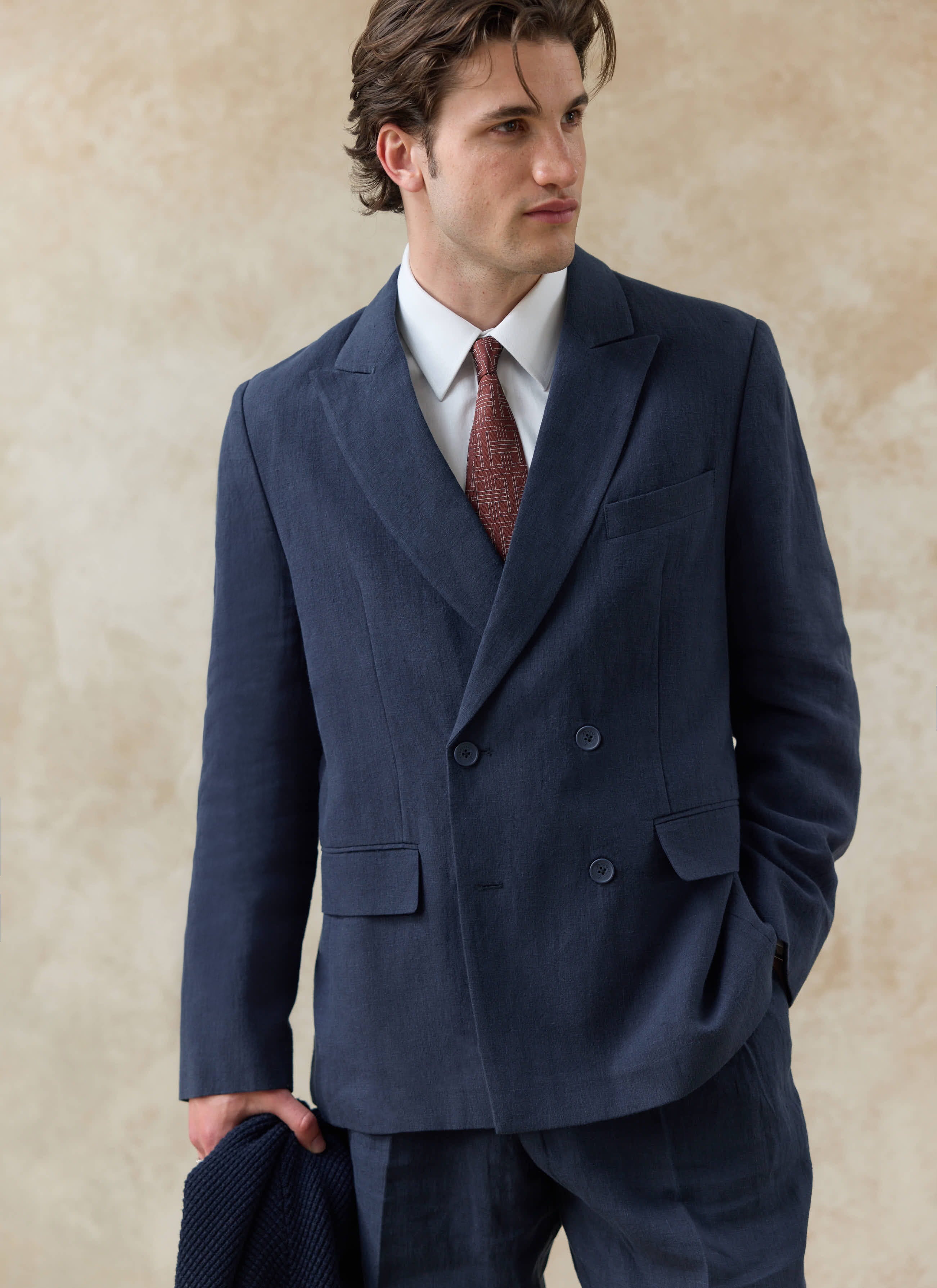 Percival navy blue linen Clifton double breasted blazer, styled on a model with a white shirt and patterned tie.