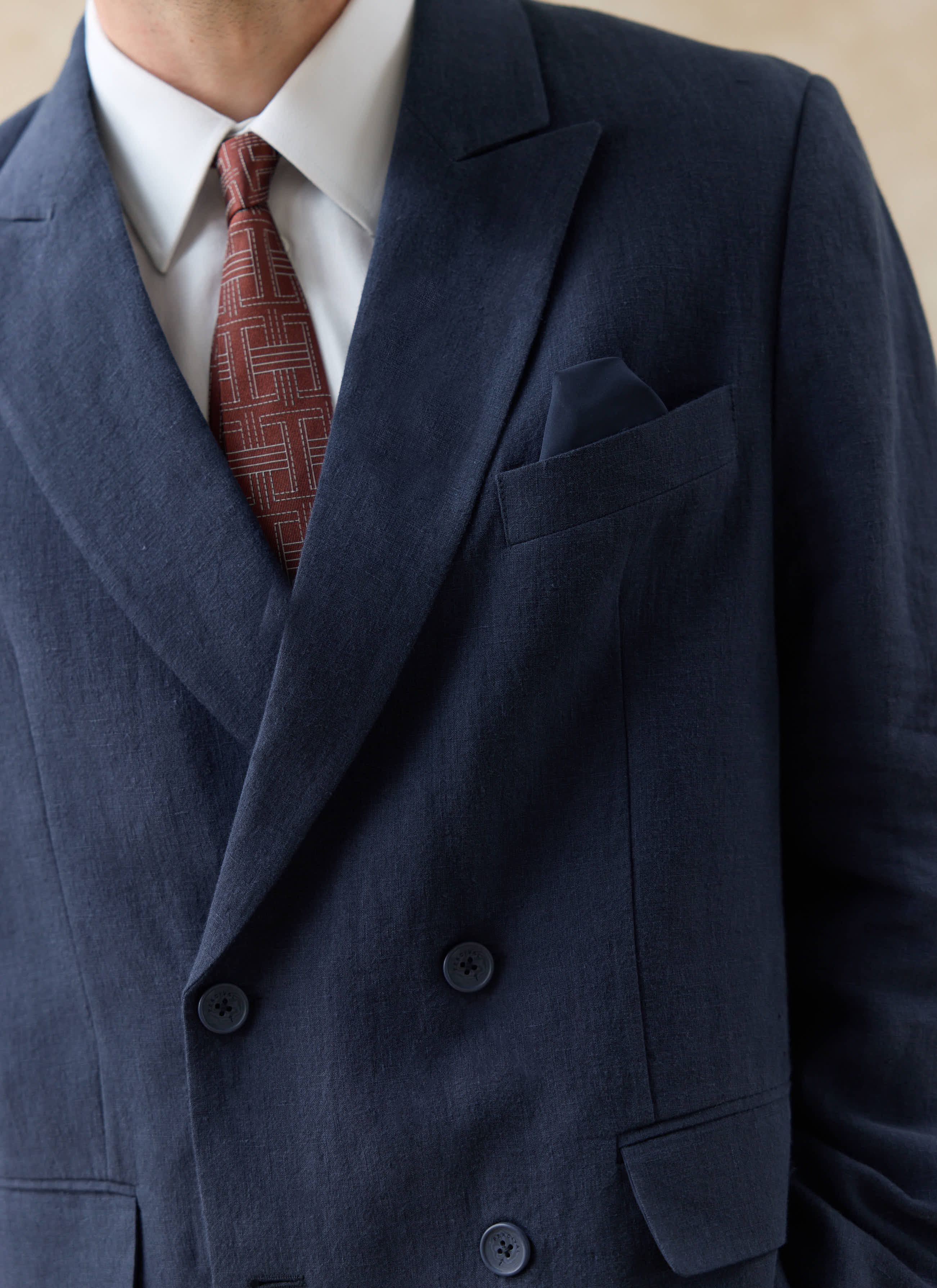 Close-up of the navy linen Clifton double breasted blazer by Percival, showing the wide lapels and textured material.