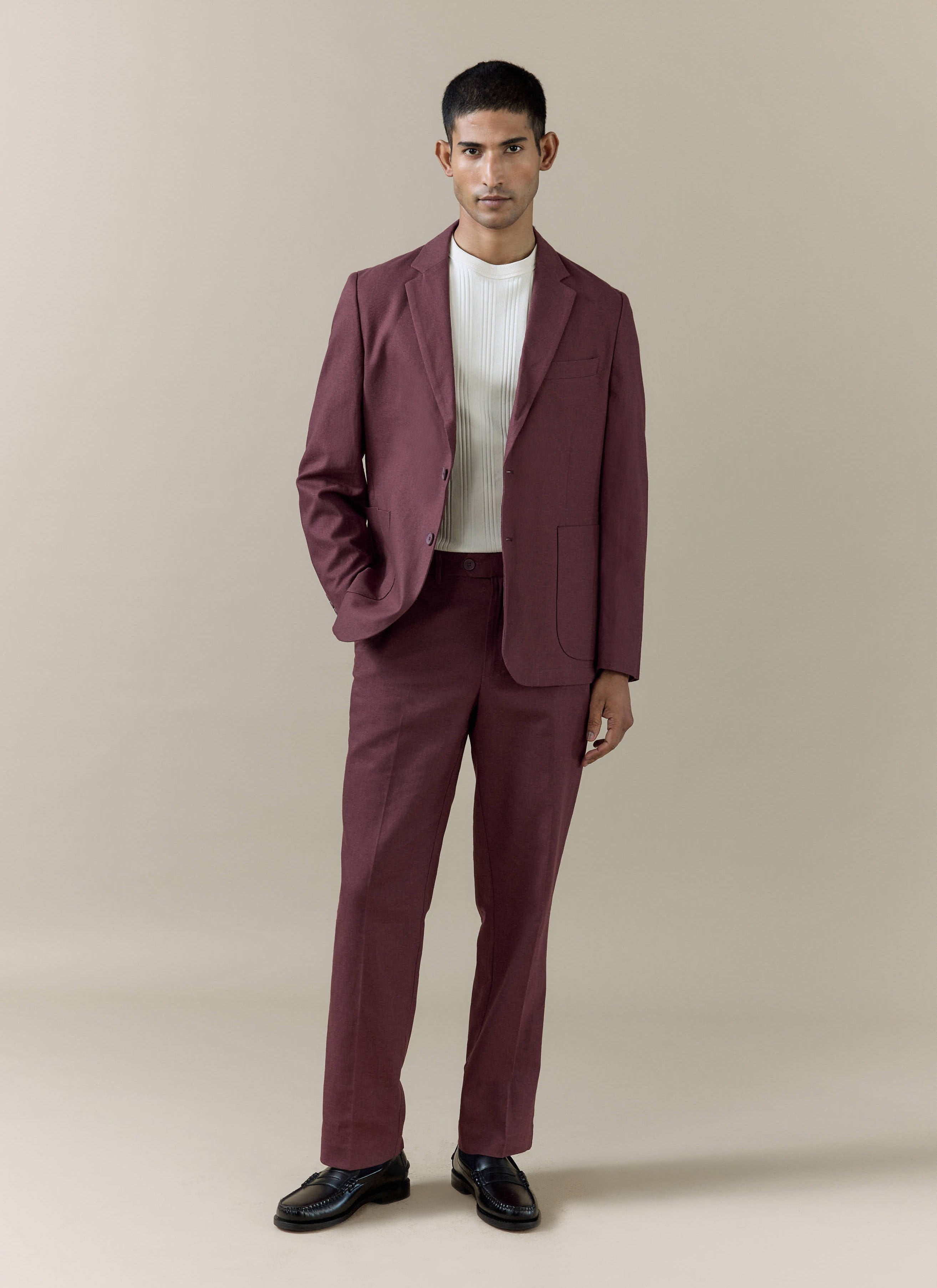 Percival Merlot tailored linen trousers and matching blazer styled with a white top and black loafers.