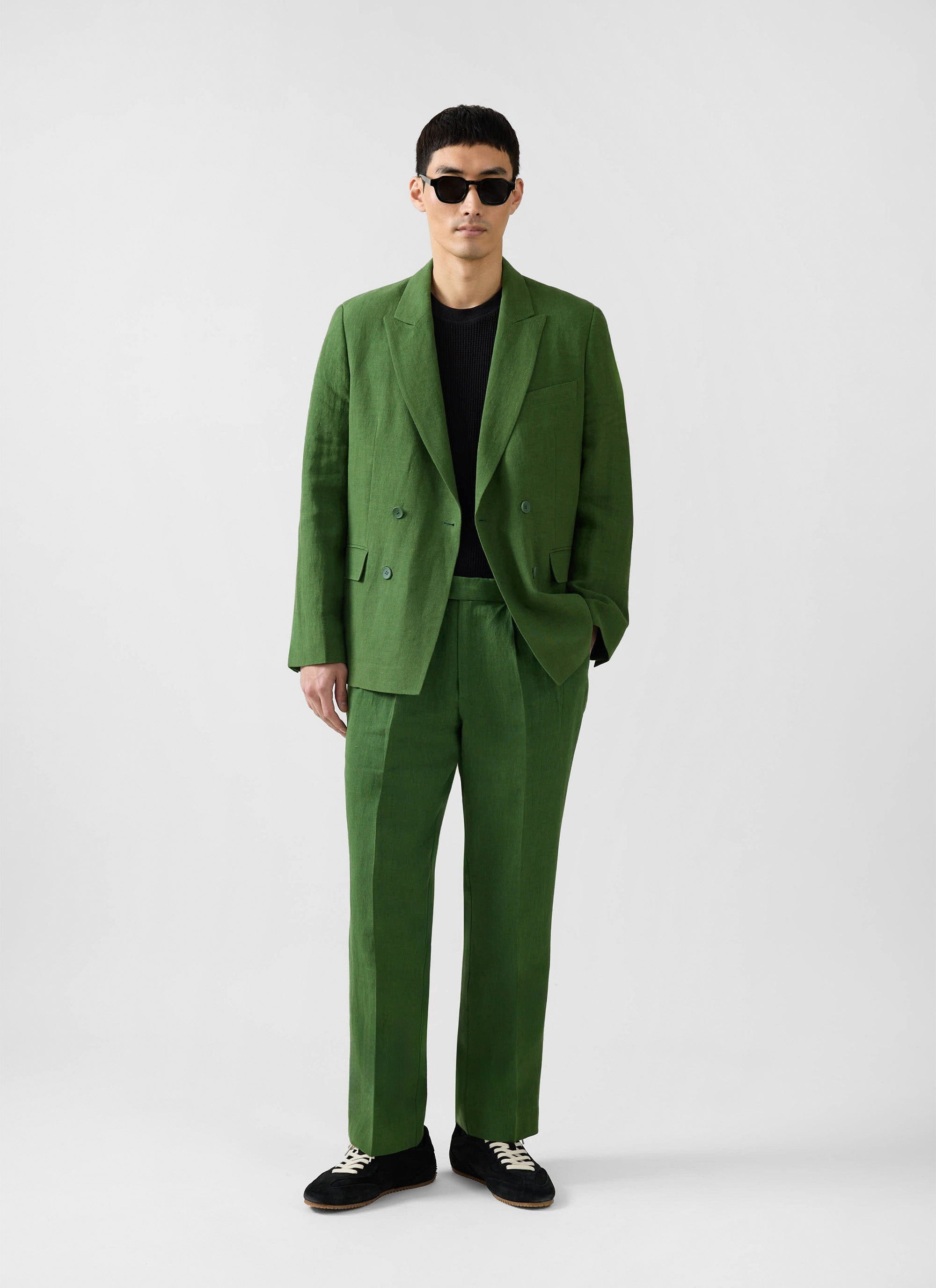 Model wearing the Percival Clifton Double Breasted Blazer in forest green linen with matching trousers.