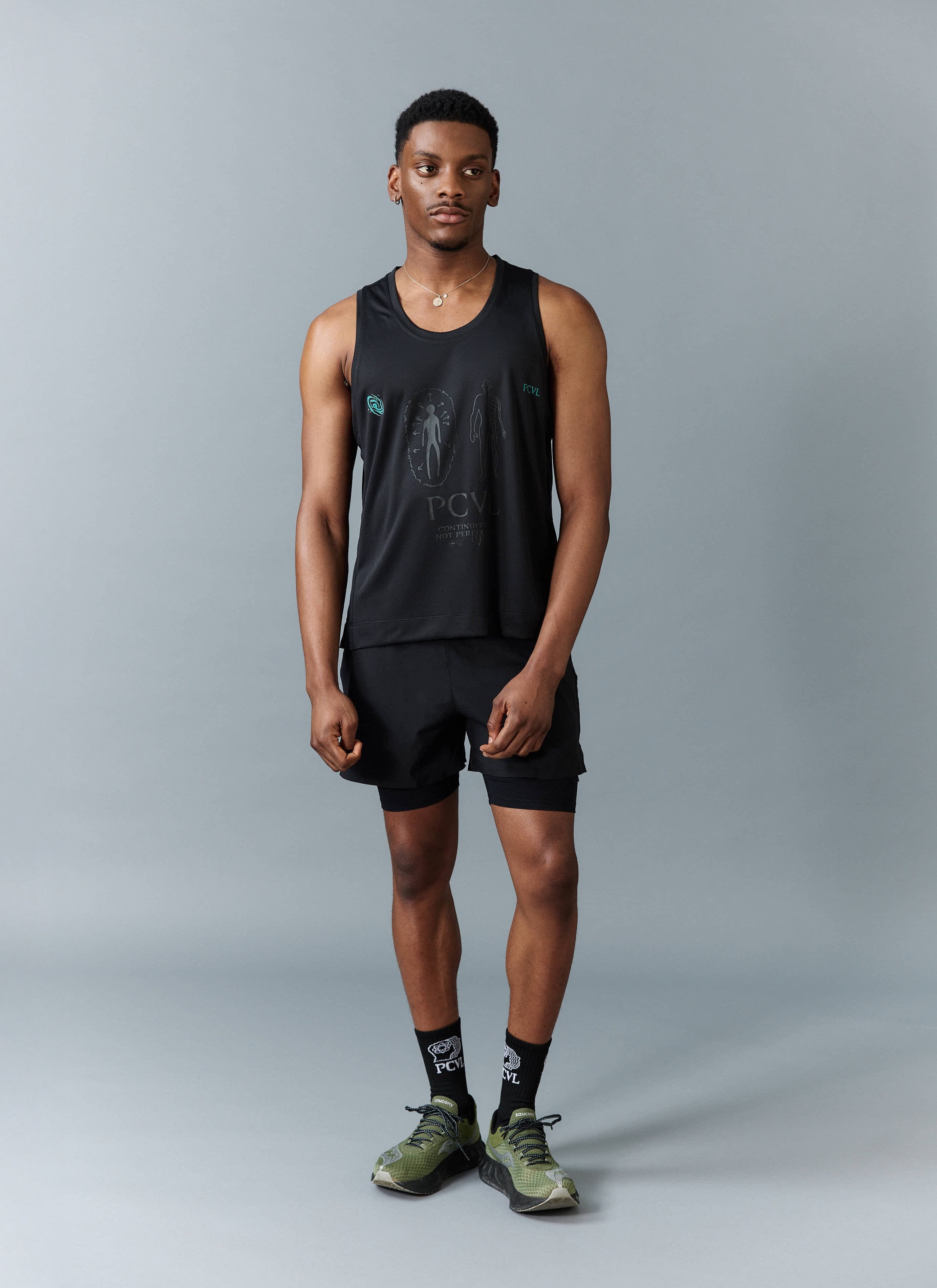 A model wears the Percival PCVL technical printed performance vest in black, styled with matching shorts, socks and trainers.