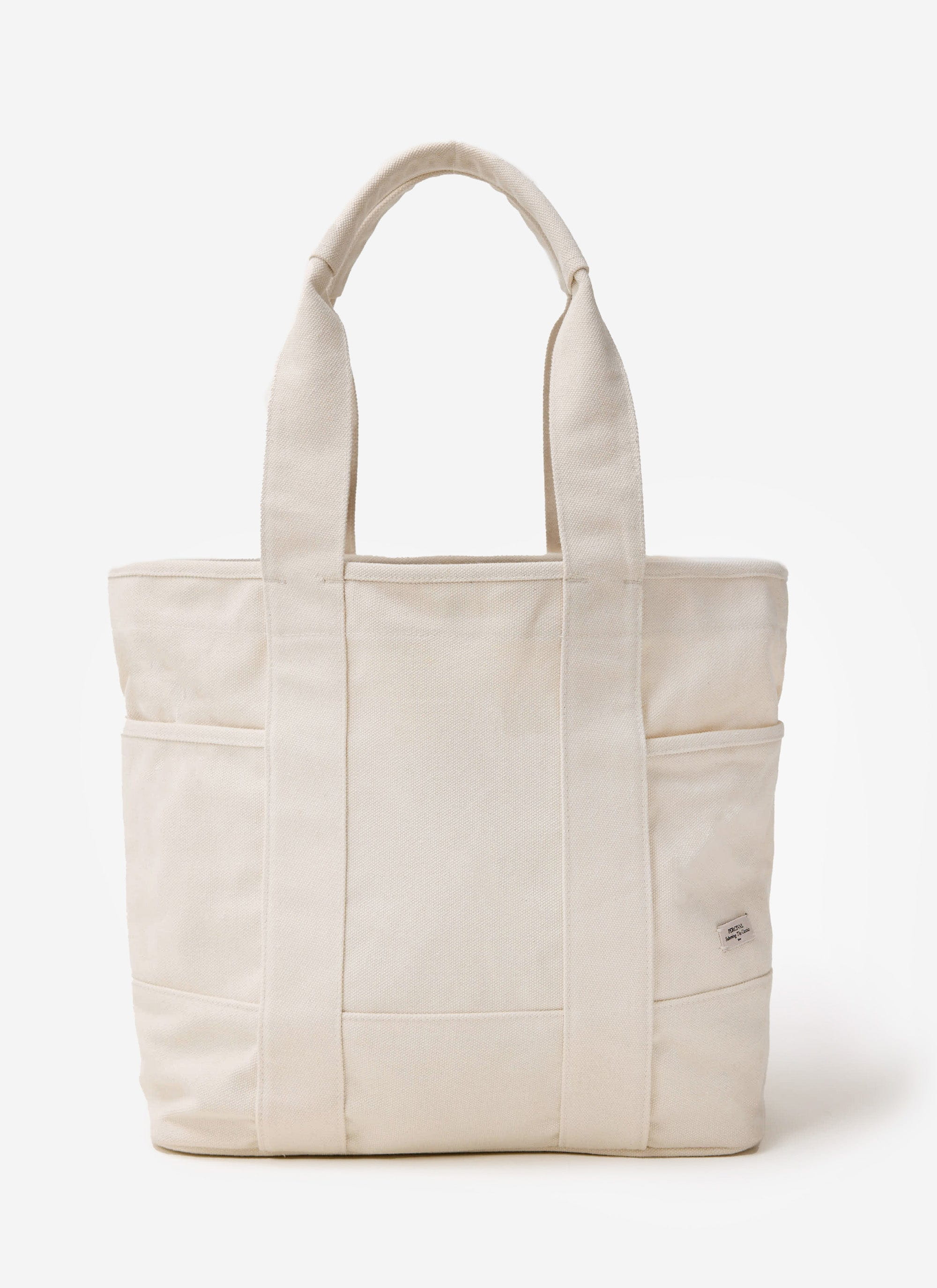 The Percival heavy-weight cotton canvas tote bag in ecru, featuring handles and external pockets, on a white background.