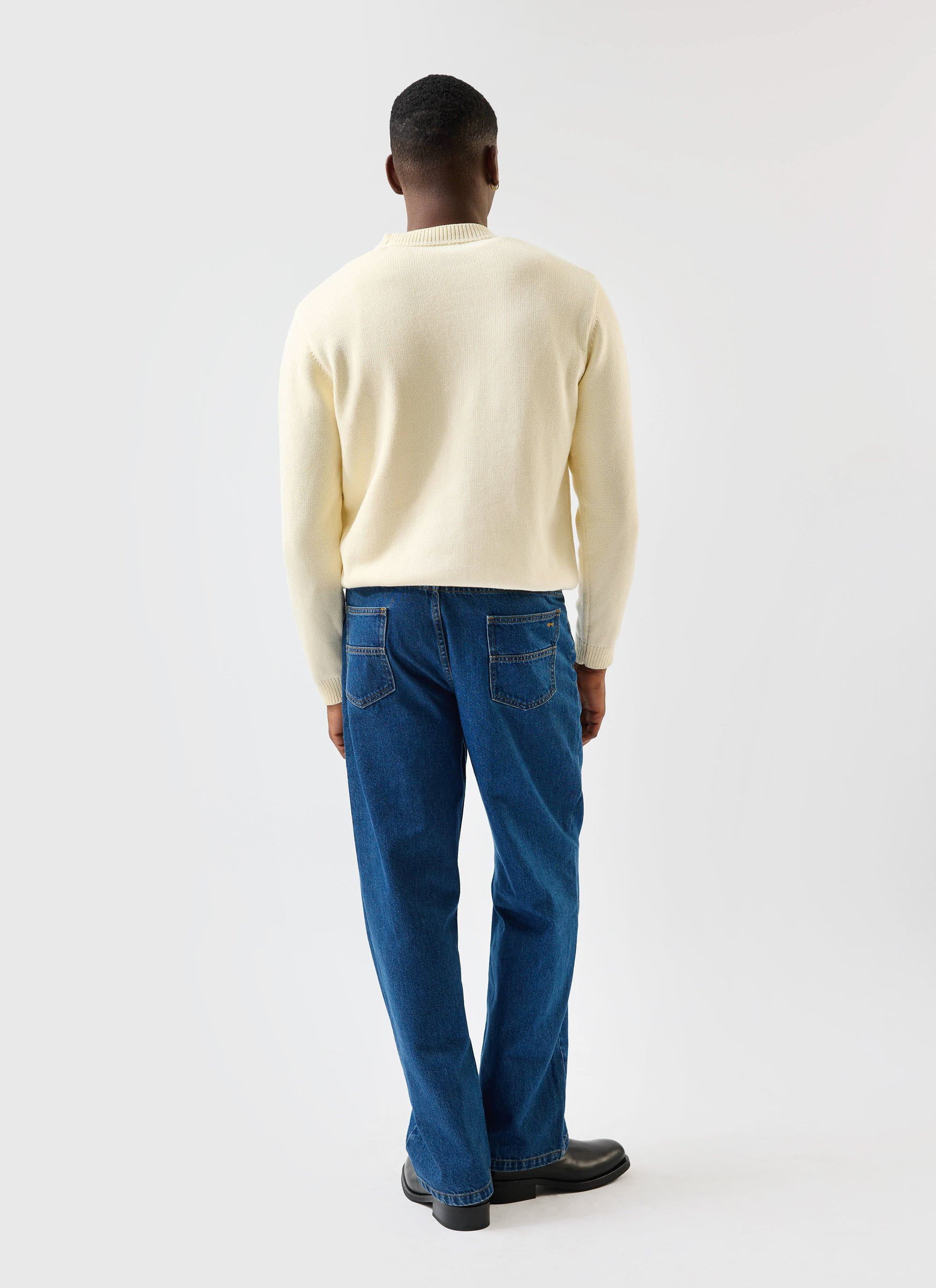 The back of a model wearing the ecru cream Public Library wool-blend knitted jumper from Percival.
