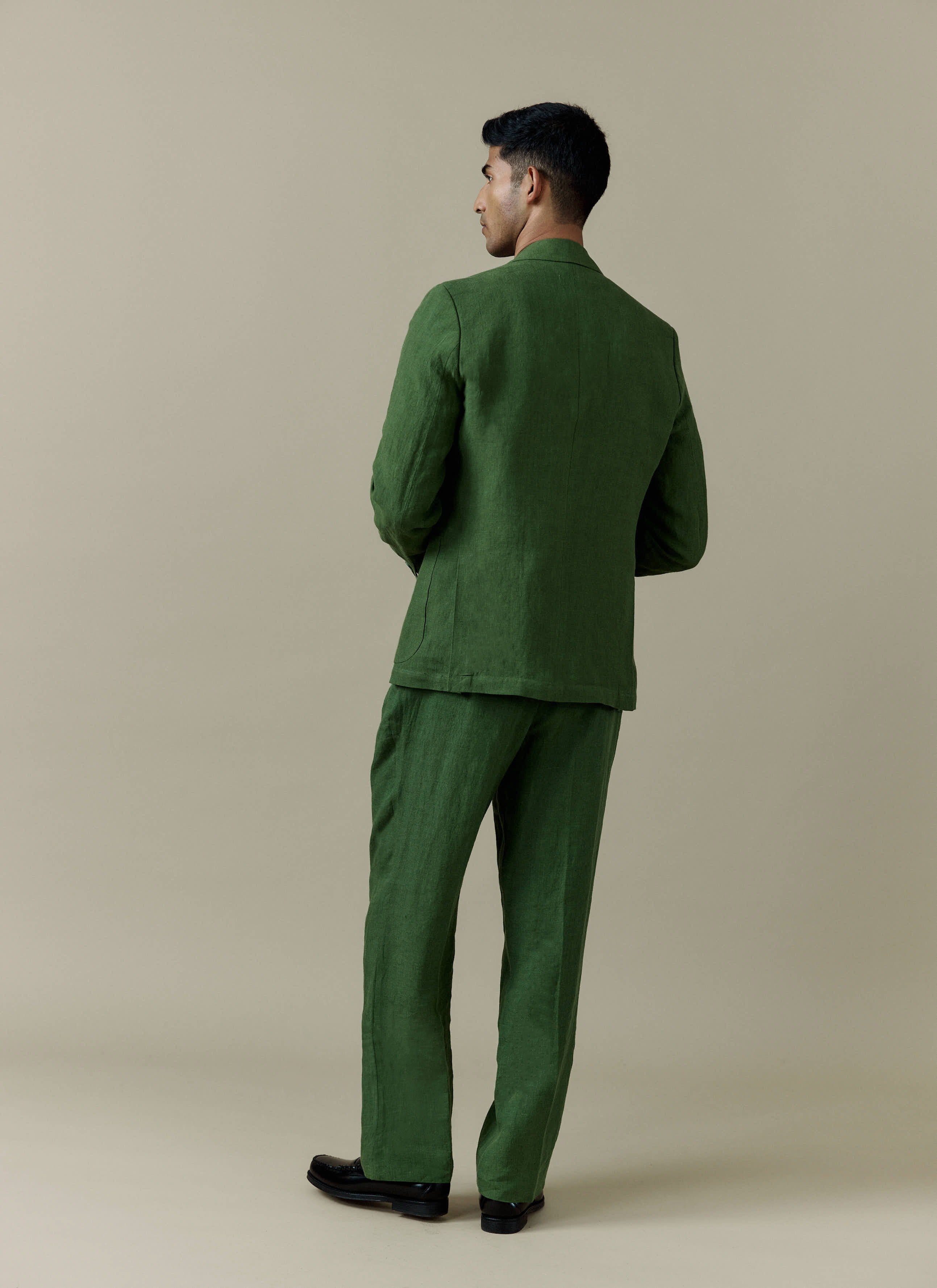 Forest green tailored linen blazer and matching suit trousers by Percival, viewed from the back.