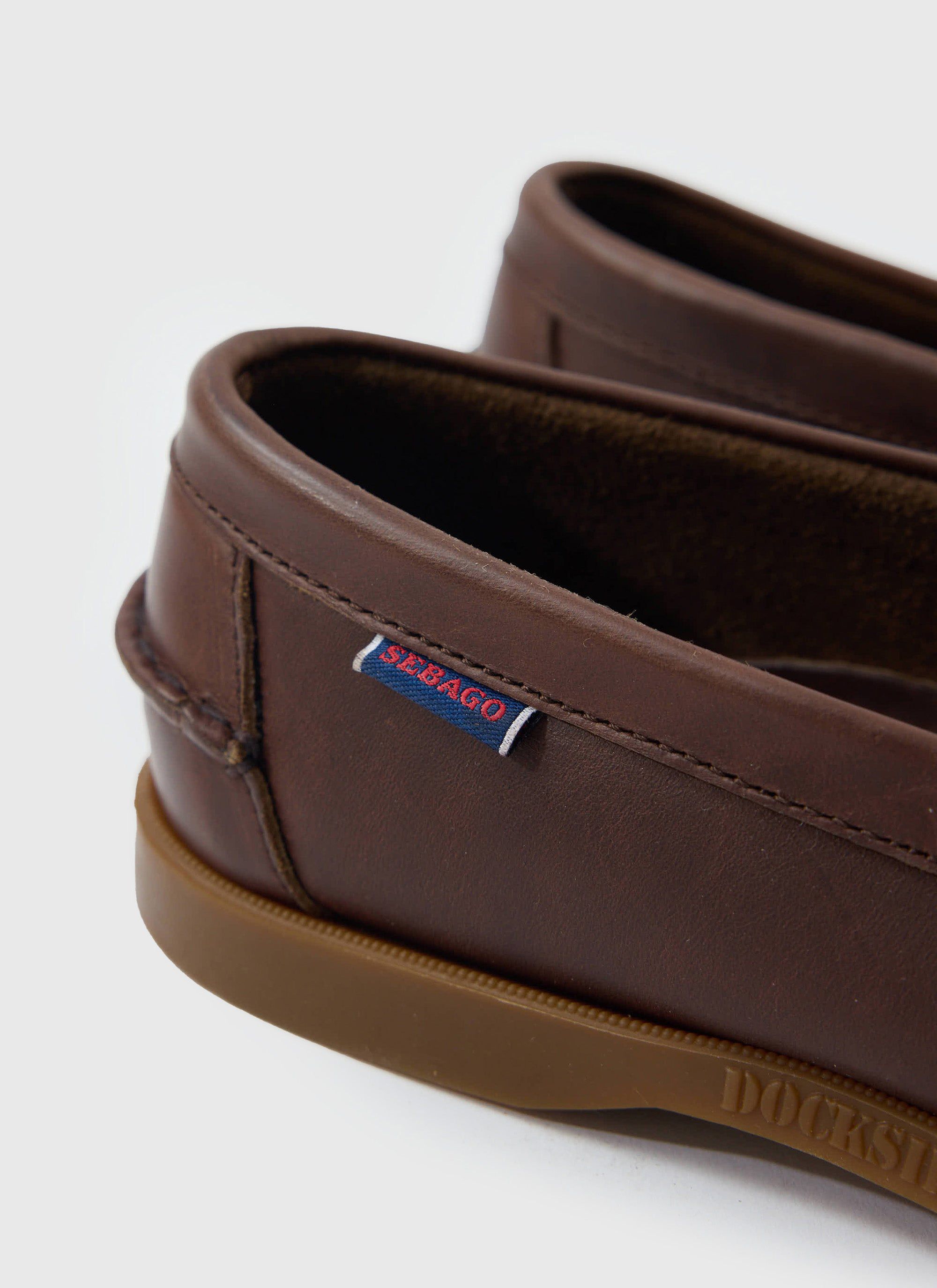 A close-up detail of the dark brown leather Sebago Loafer from Percival, highlighting the signature side tag.