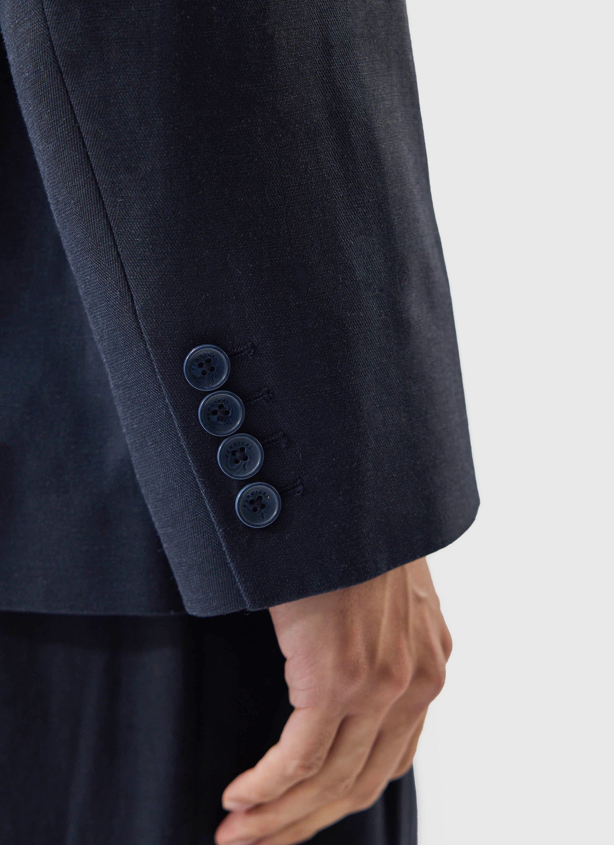 Close-up detail of the sleeve cuff and branded buttons on the navy Lyocell Tailored Blazer from Percival.