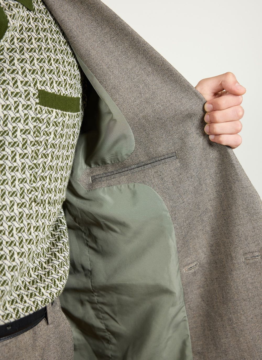 Close up of the inside of the Percival grey herringbone blazer, showing the lining and internal pocket.