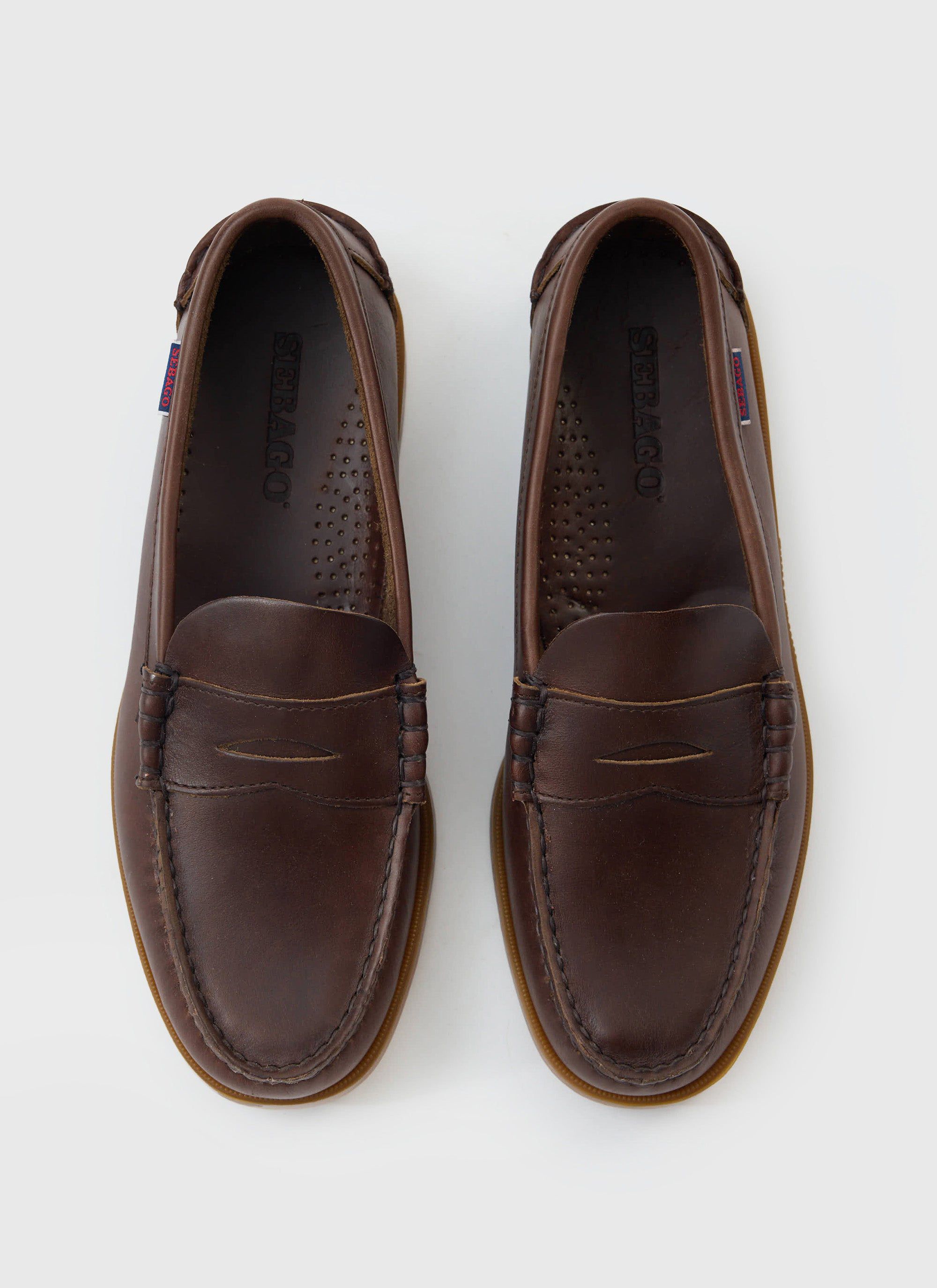 A pair of Sebago Dolphin Waxed loafers in dark brown leather, available from Percival, shot from above on a white background.