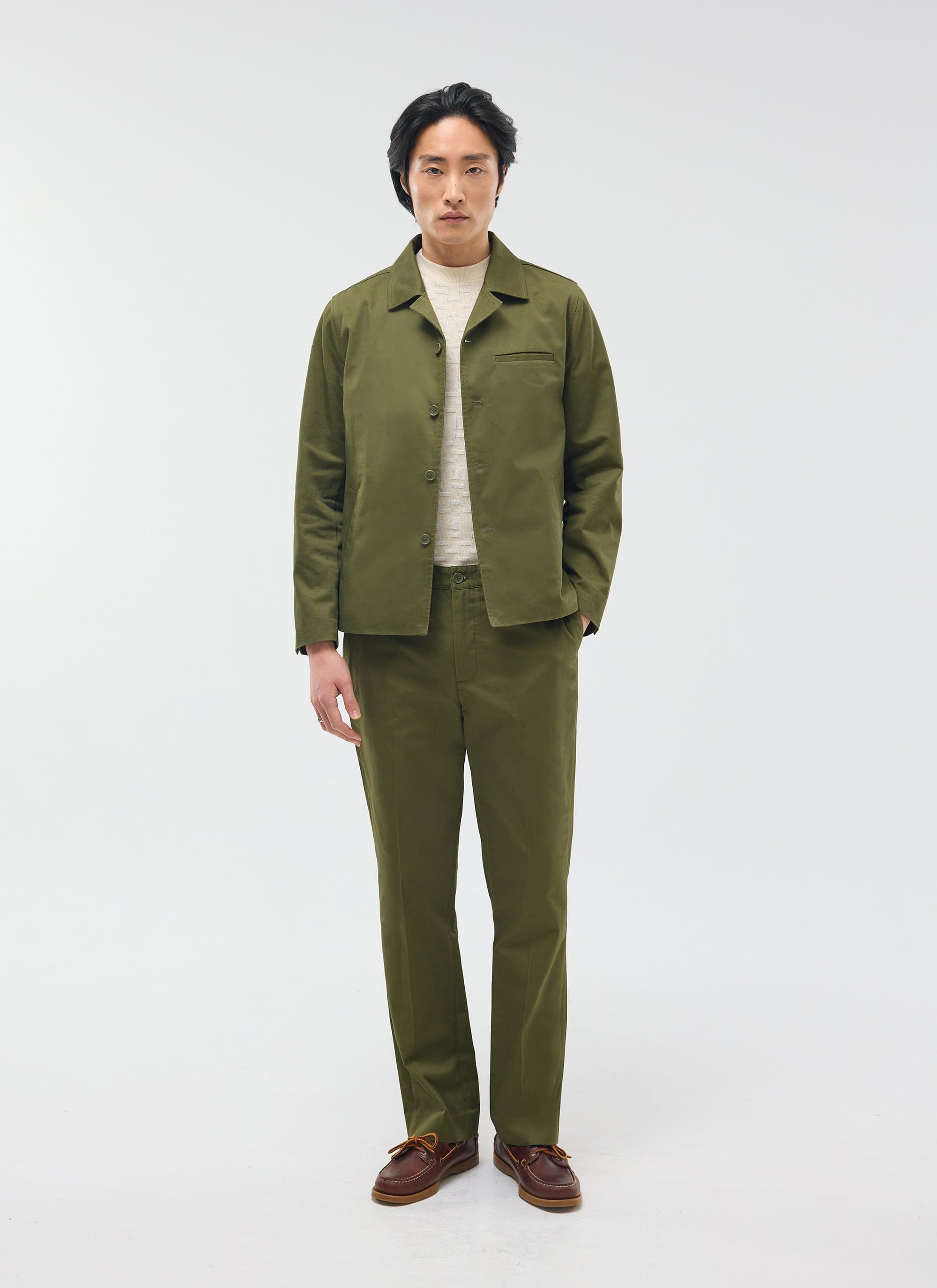 The Percival Casual Workwear Jacket in khaki cotton, styled on a model with matching trousers and a cream jumper.