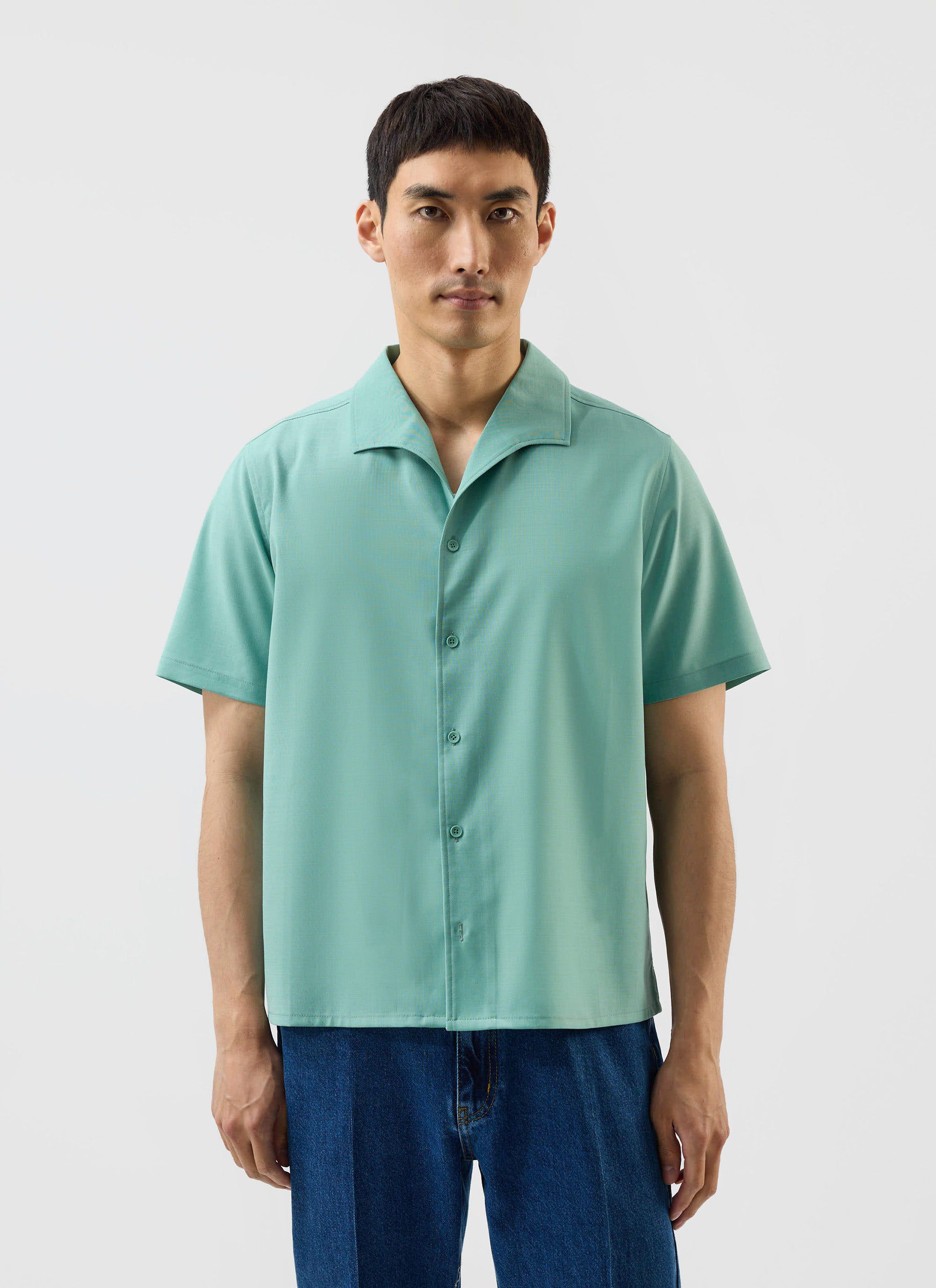 A man models the Percival x Warren Drape Cuban Shirt in mint green against a white studio background.