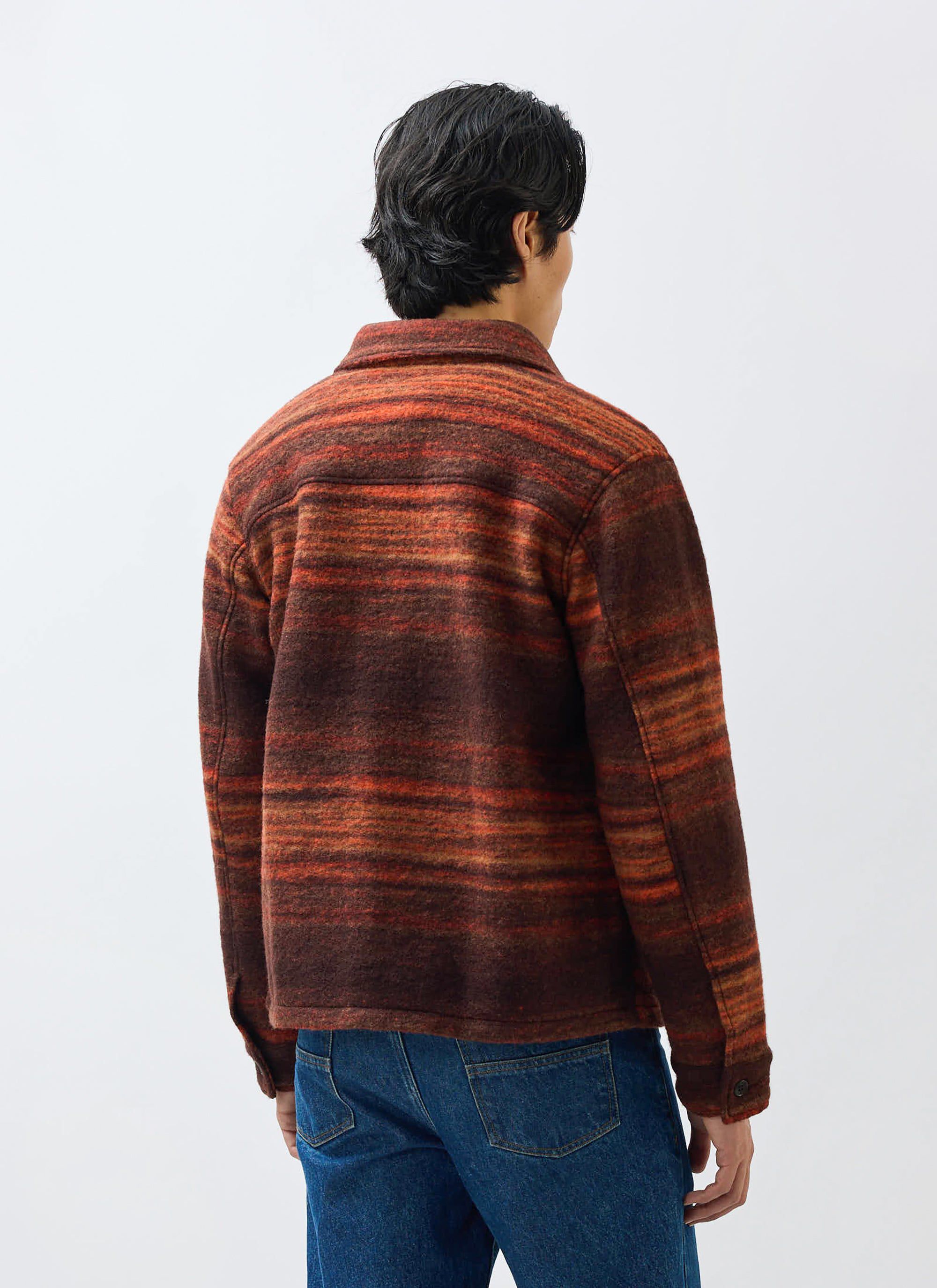 A model seen from behind, wearing the Percival Mississippi Jacquard Overshirt in a burnt orange and brown wool blend.