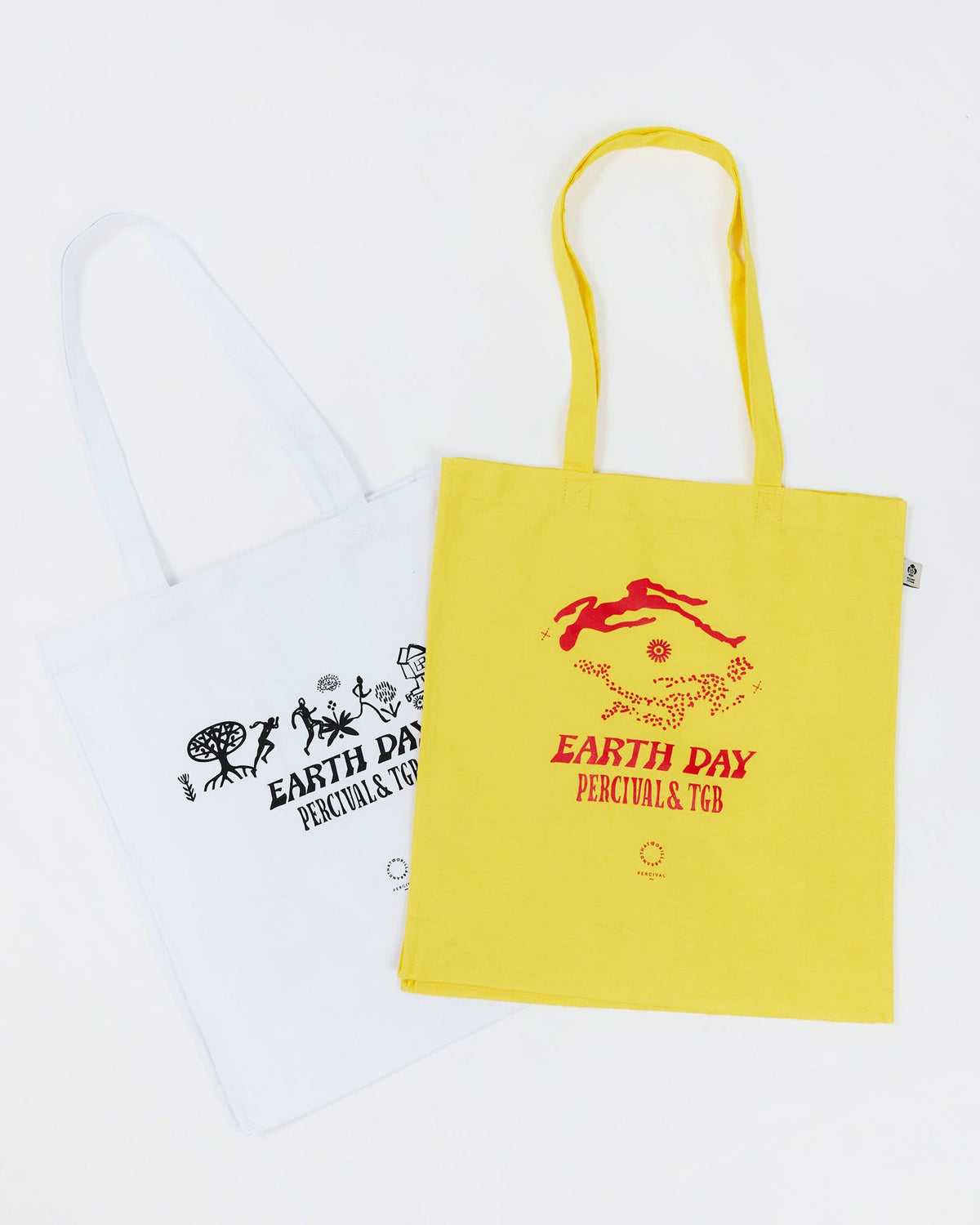 The Percival x The Gorilla Brand Earth Day tote bags in yellow and white, laid flat on a white background.