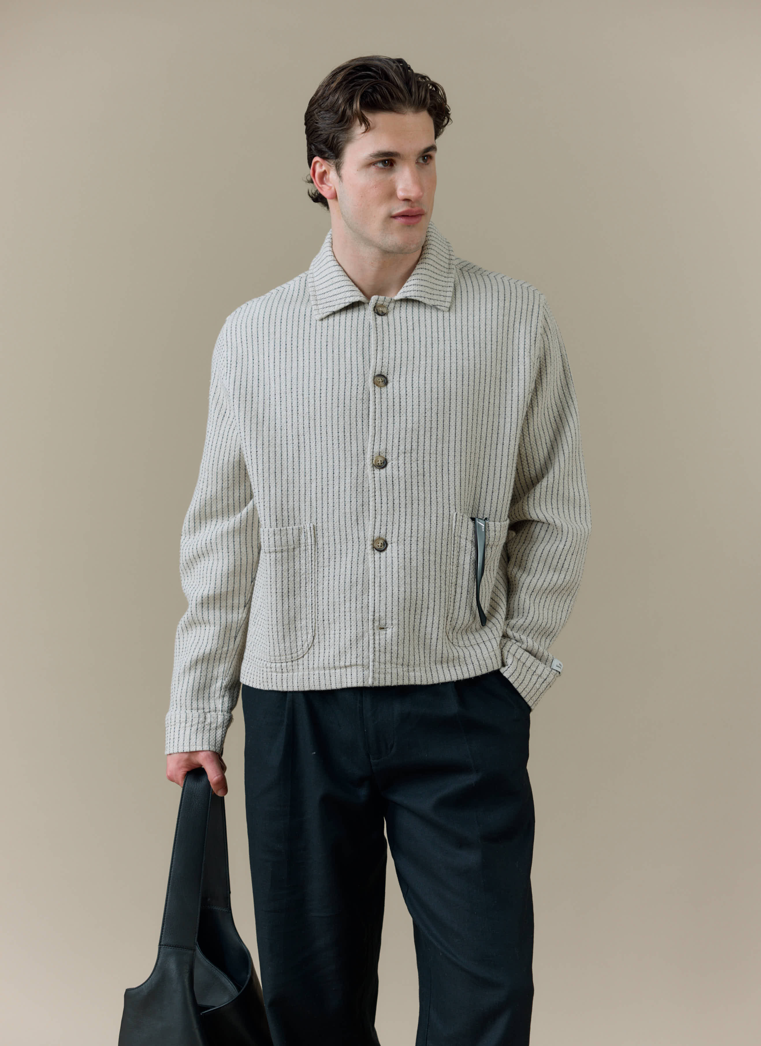 Model wearing the Percival Sorrento Boxy Overshirt in cream linen, featuring a textured vertical weave and boxy fit.
