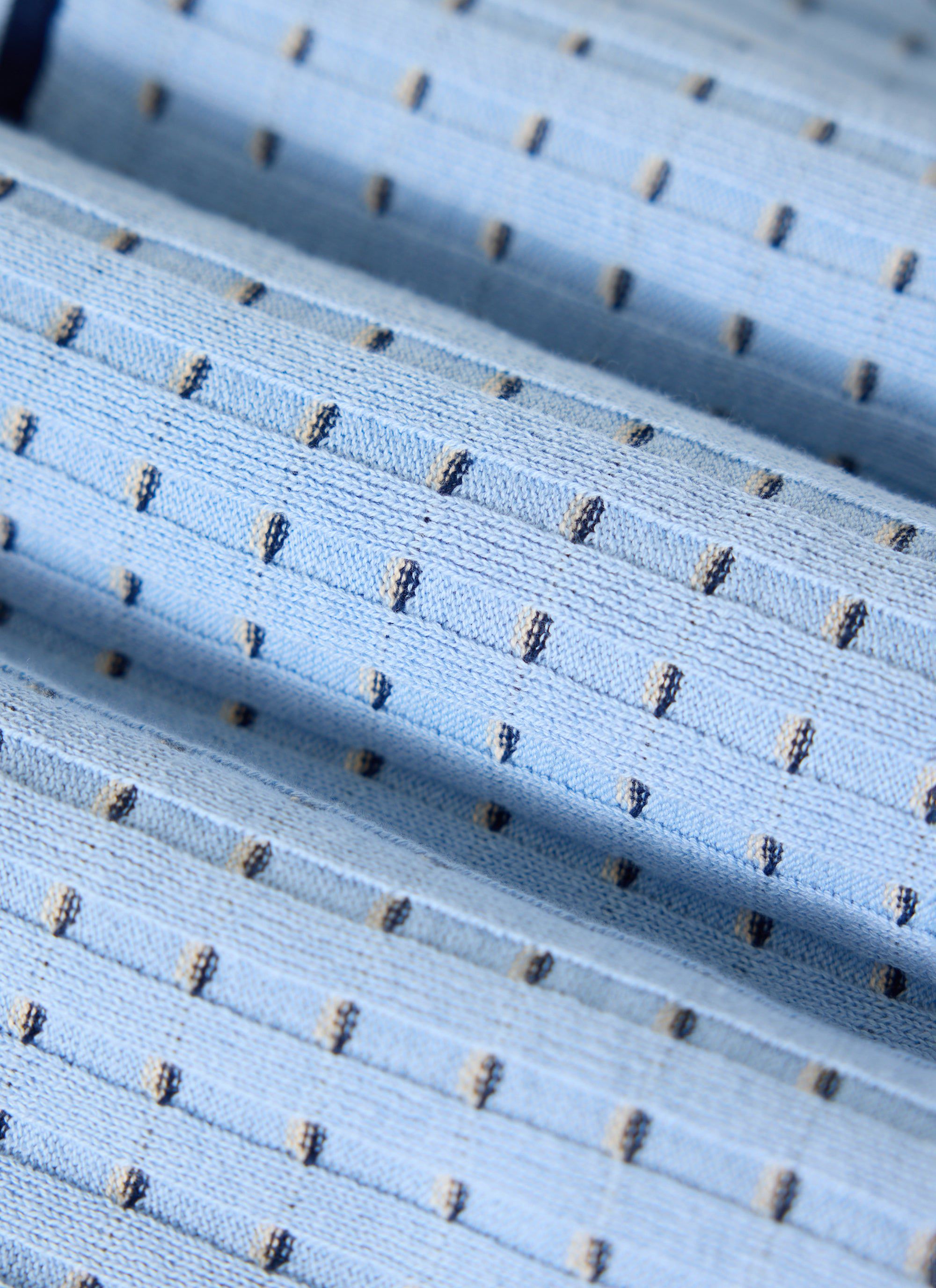 Close-up detail of the Percival Broken Stripe Knitted Shirt in blue, showing the texture of the 100% cotton fabric.