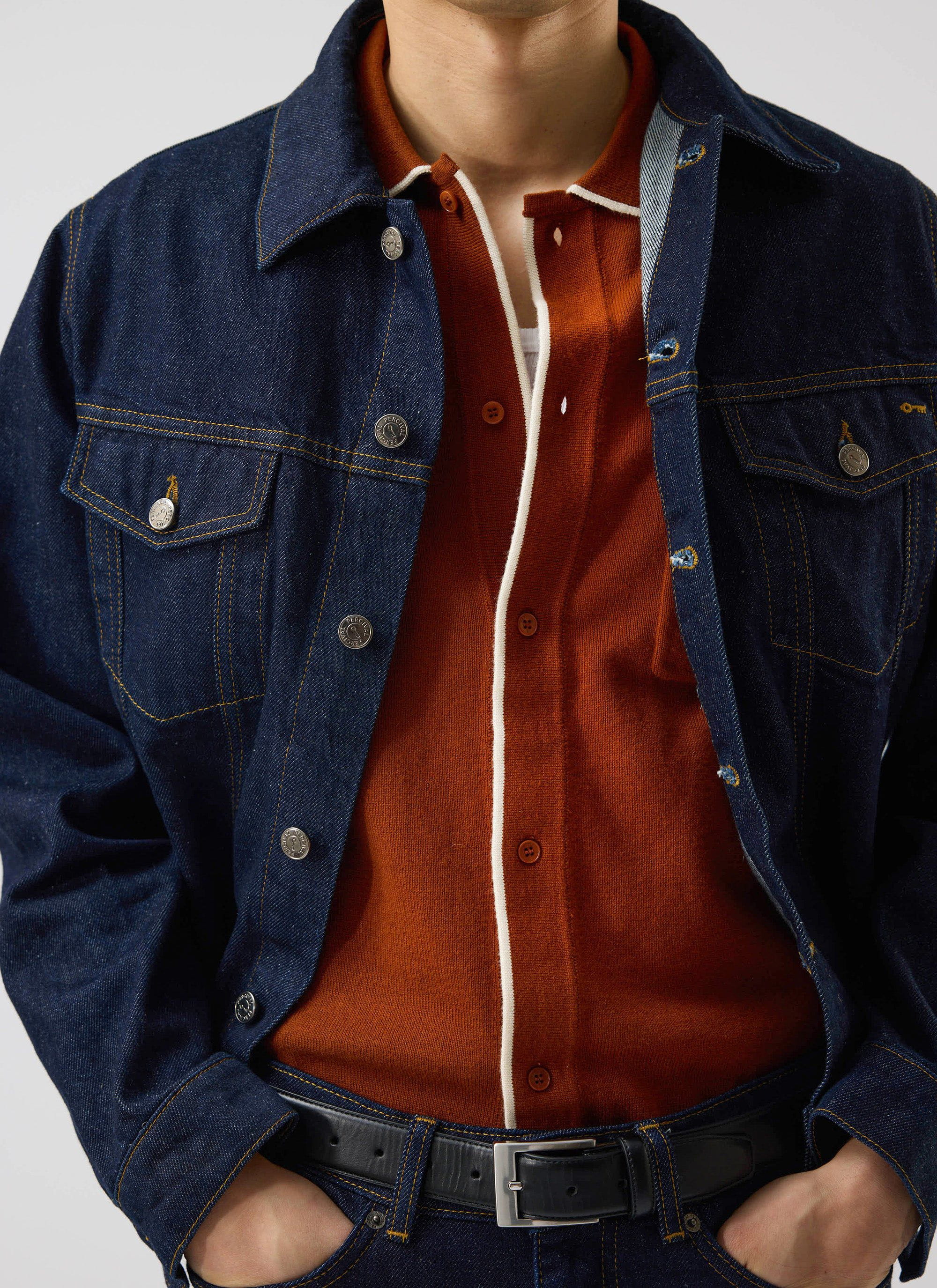 A model wears the Percival Contrast Trim Shirt in rust, layered under a dark denim jacket.