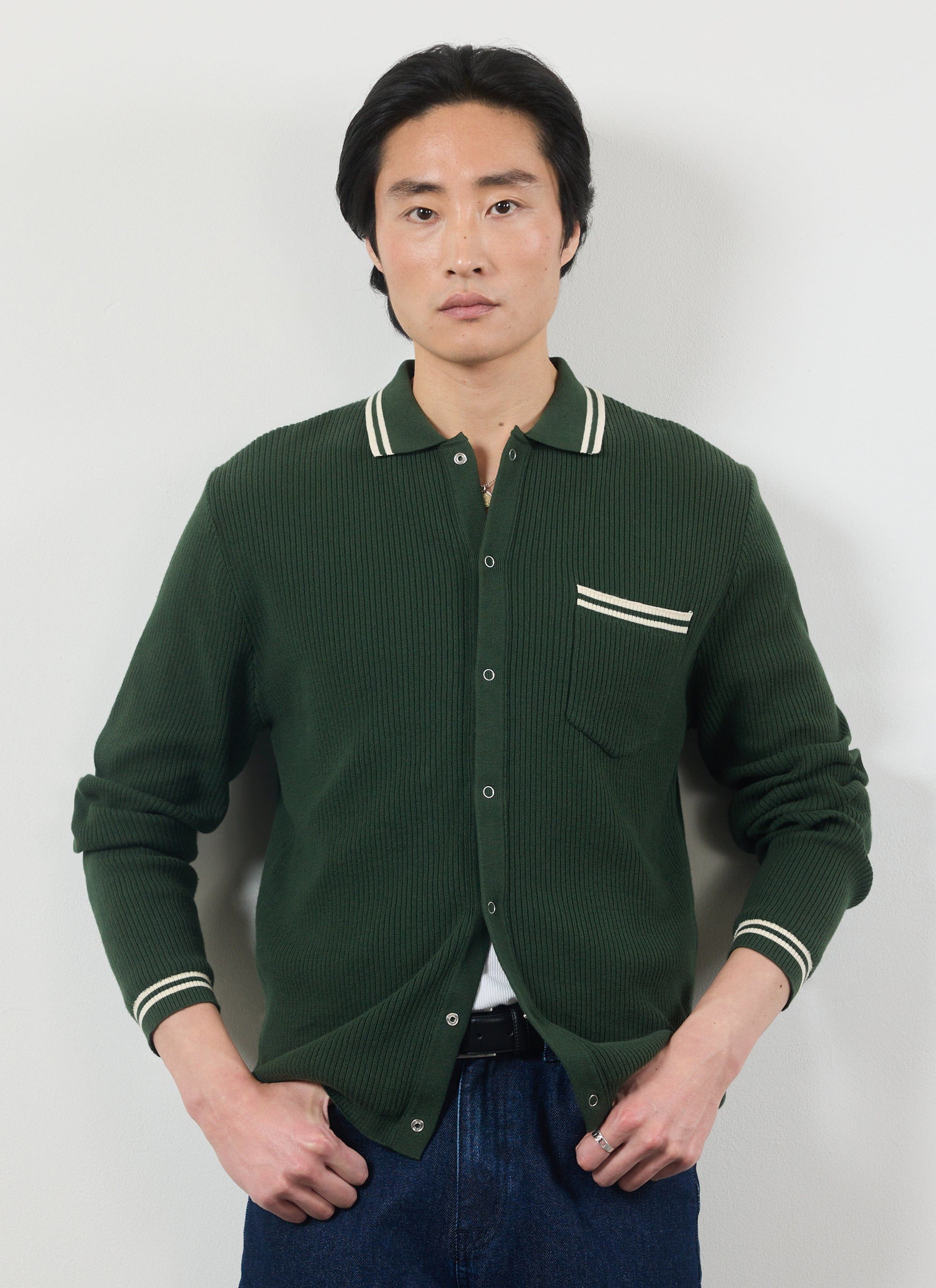 Model wears the Percival Pablo long sleeve cotton knitted shirt in forest green with white tipping on the collar and pocket.