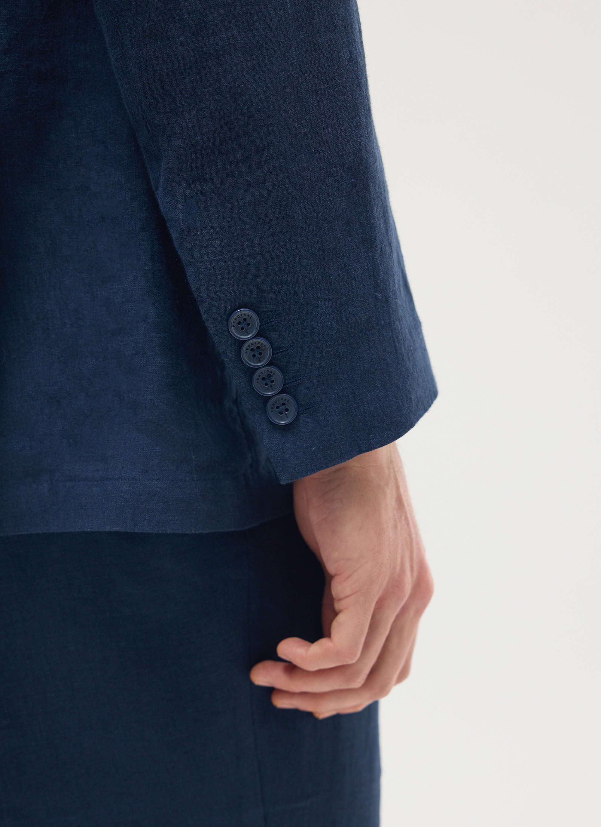 Close up of the cuff and buttons on the navy linen double breasted blazer from Percival.