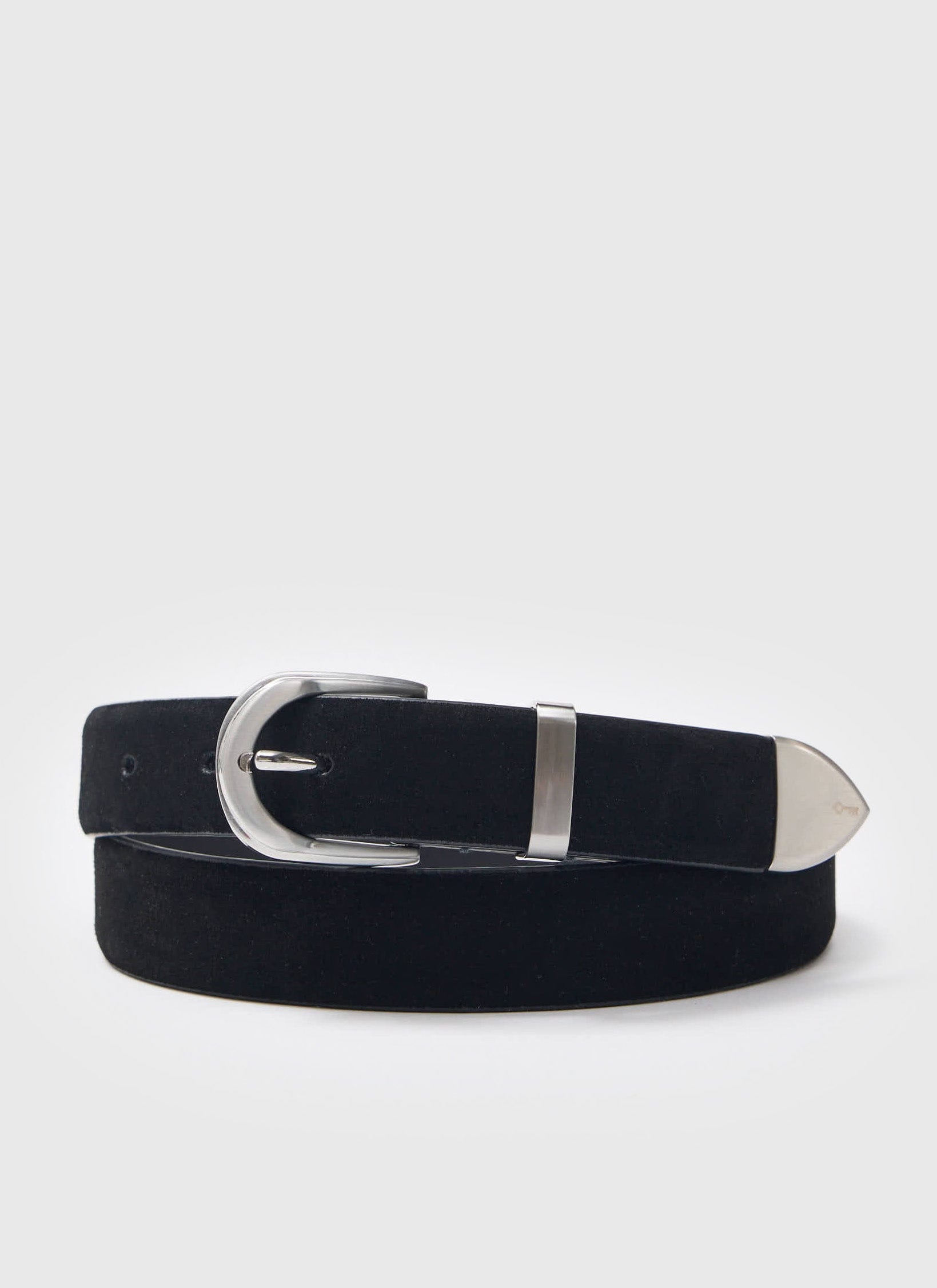 The black suede leather belt from Percival, with a silver western-style buckle and tip, coiled against a white background.