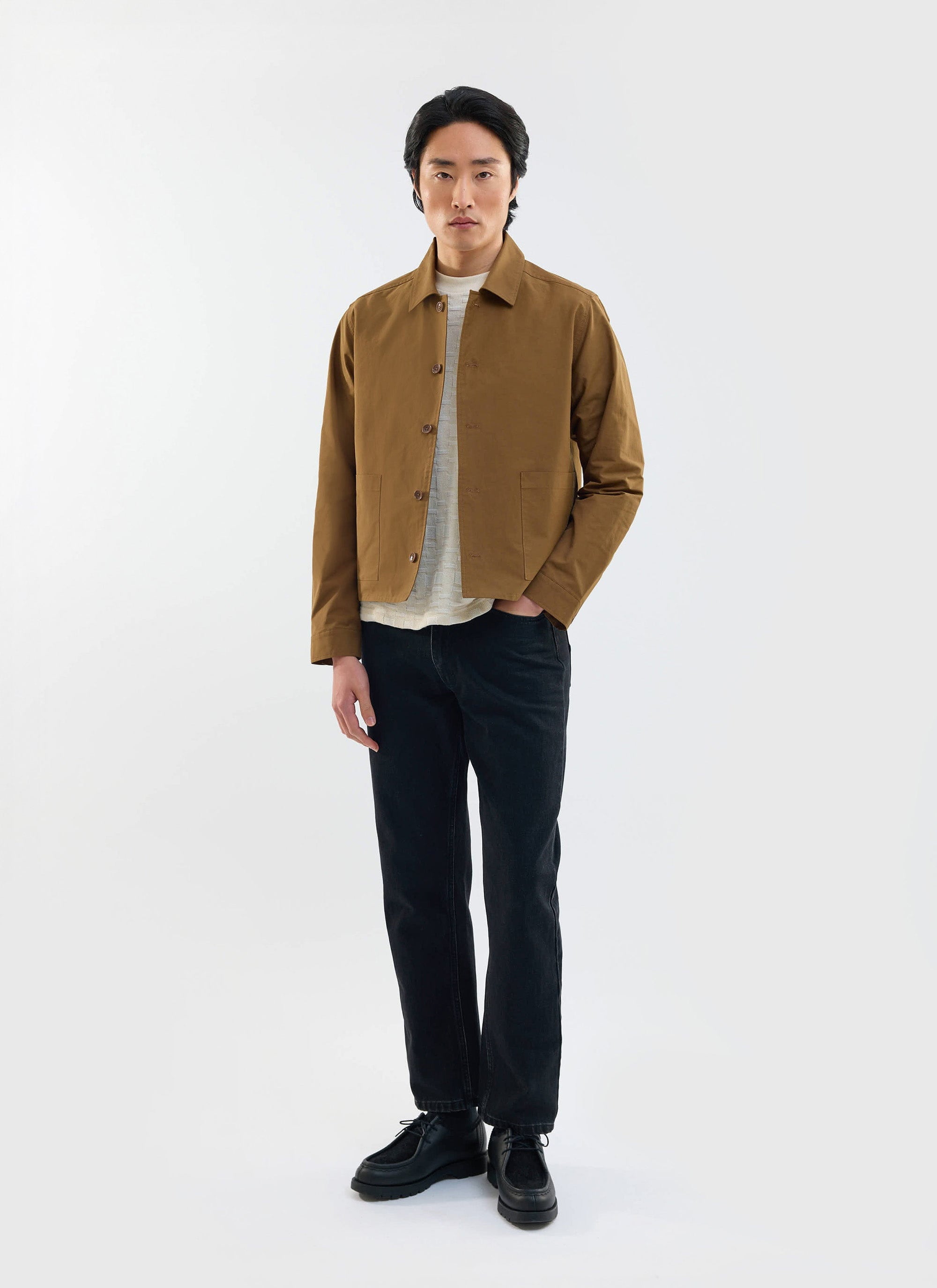 A model wears the Percival Boxy Cropped Pocket Overshirt in brown, styled with black jeans and a white tee.