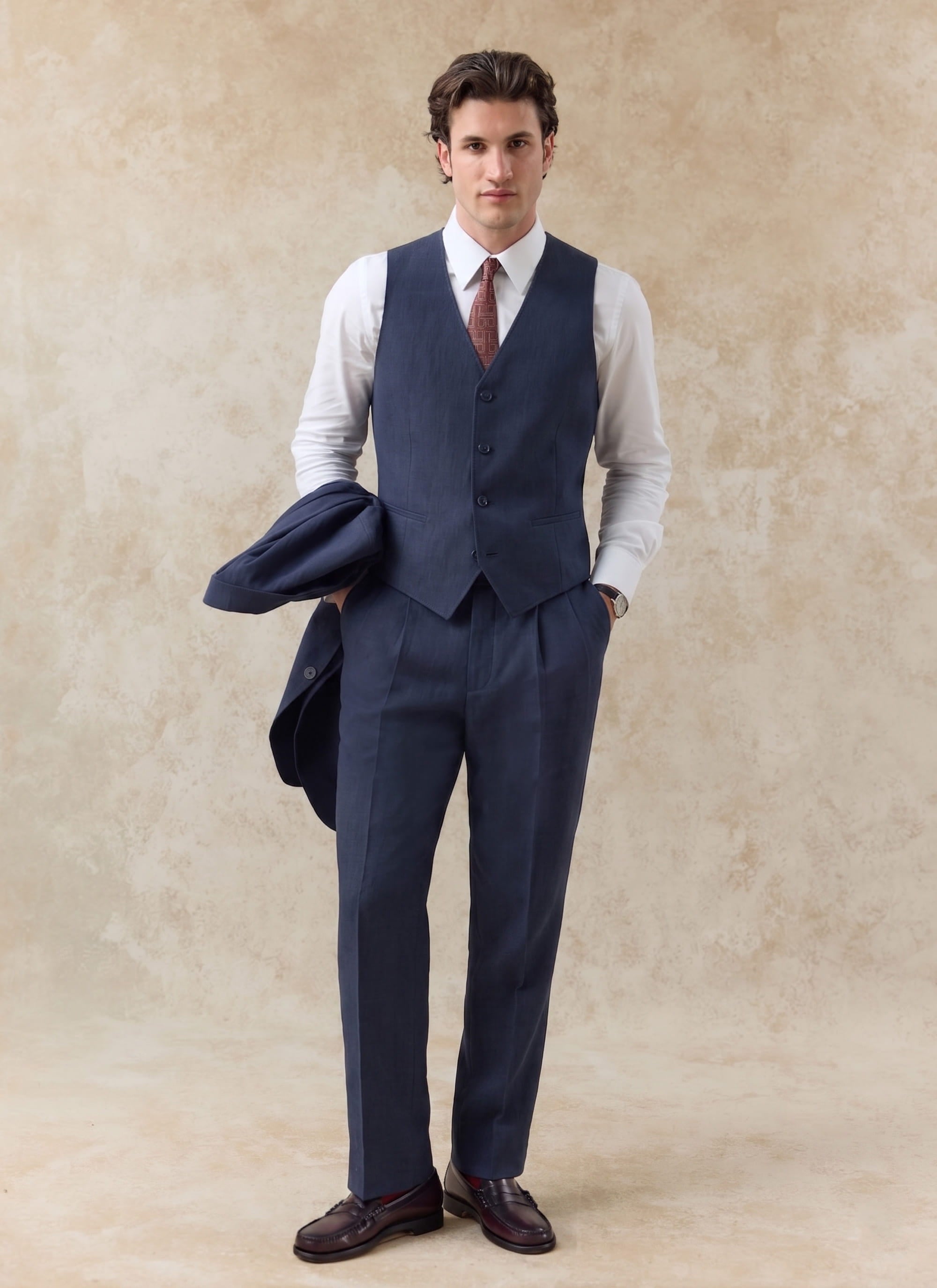 Navy linen waistcoat by Percival, styled with matching trousers and a white shirt for a refined summer suit look.