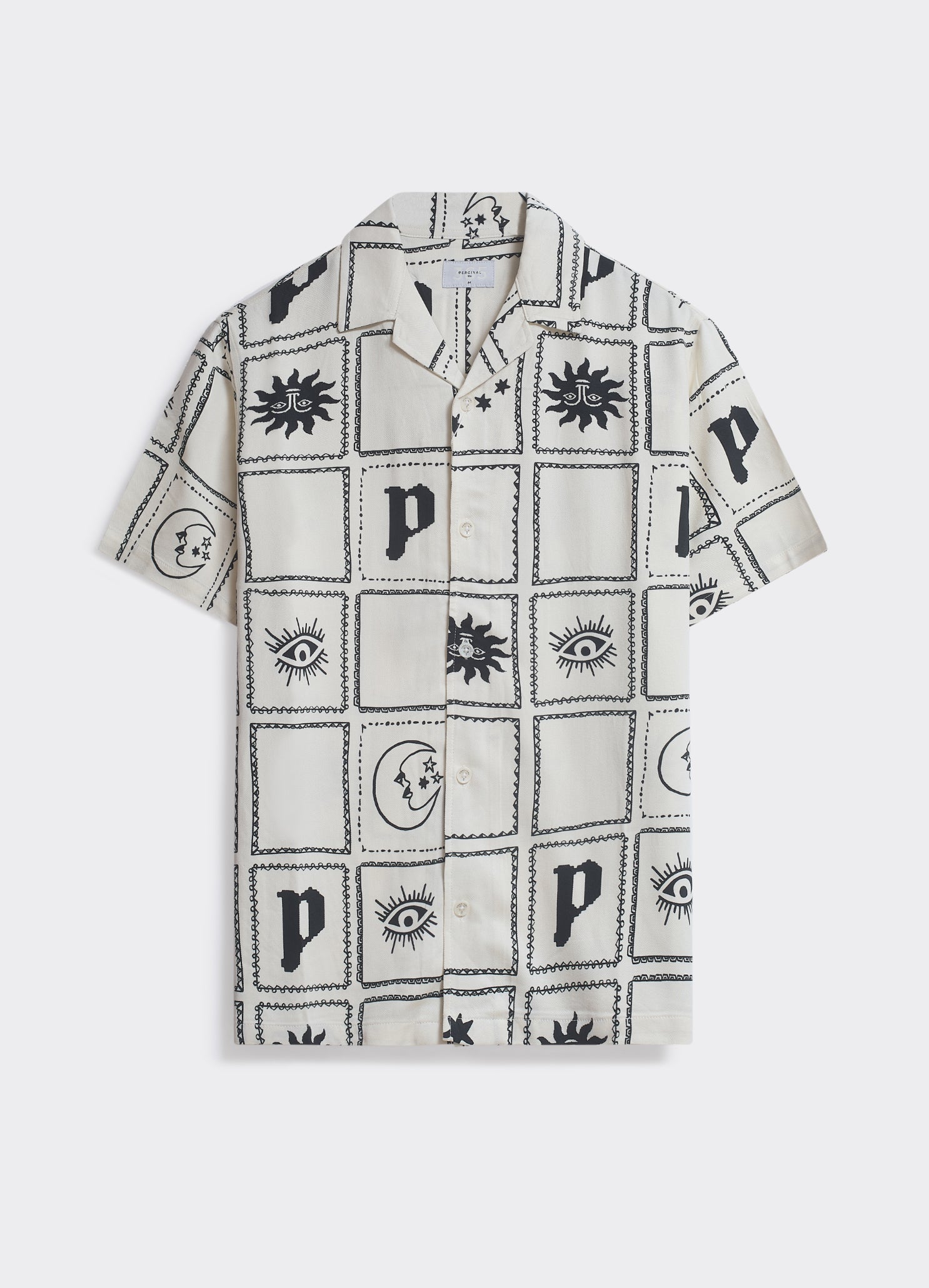The Percival Panels Shirt in cream and black, a woven camp-collar shirt with an all-over sun, moon, and eye grid print.