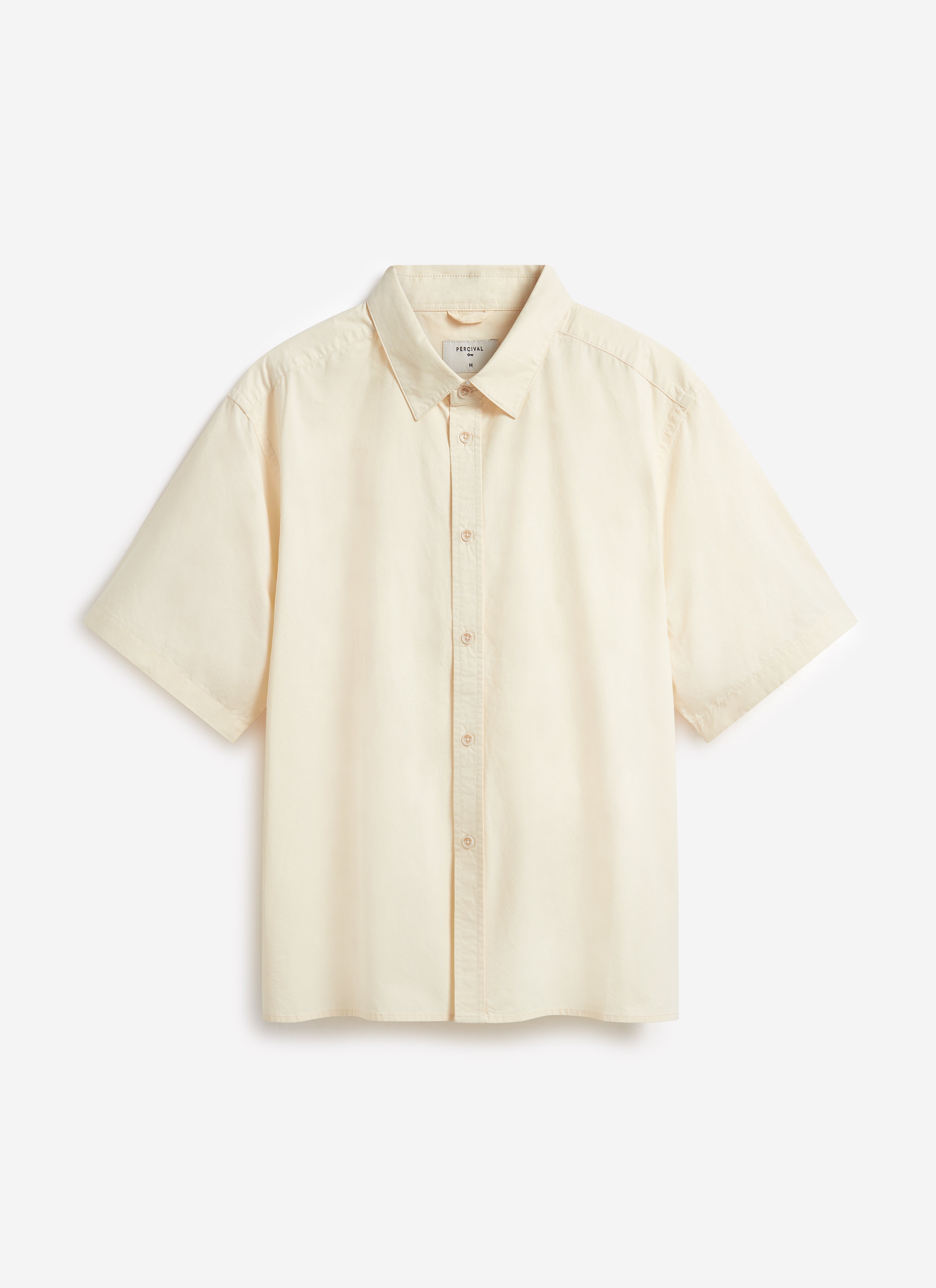 A flat lay of the Percival Boxy Cropped Clerk Shirt in ecru, made from a lightweight paper-touch cotton.