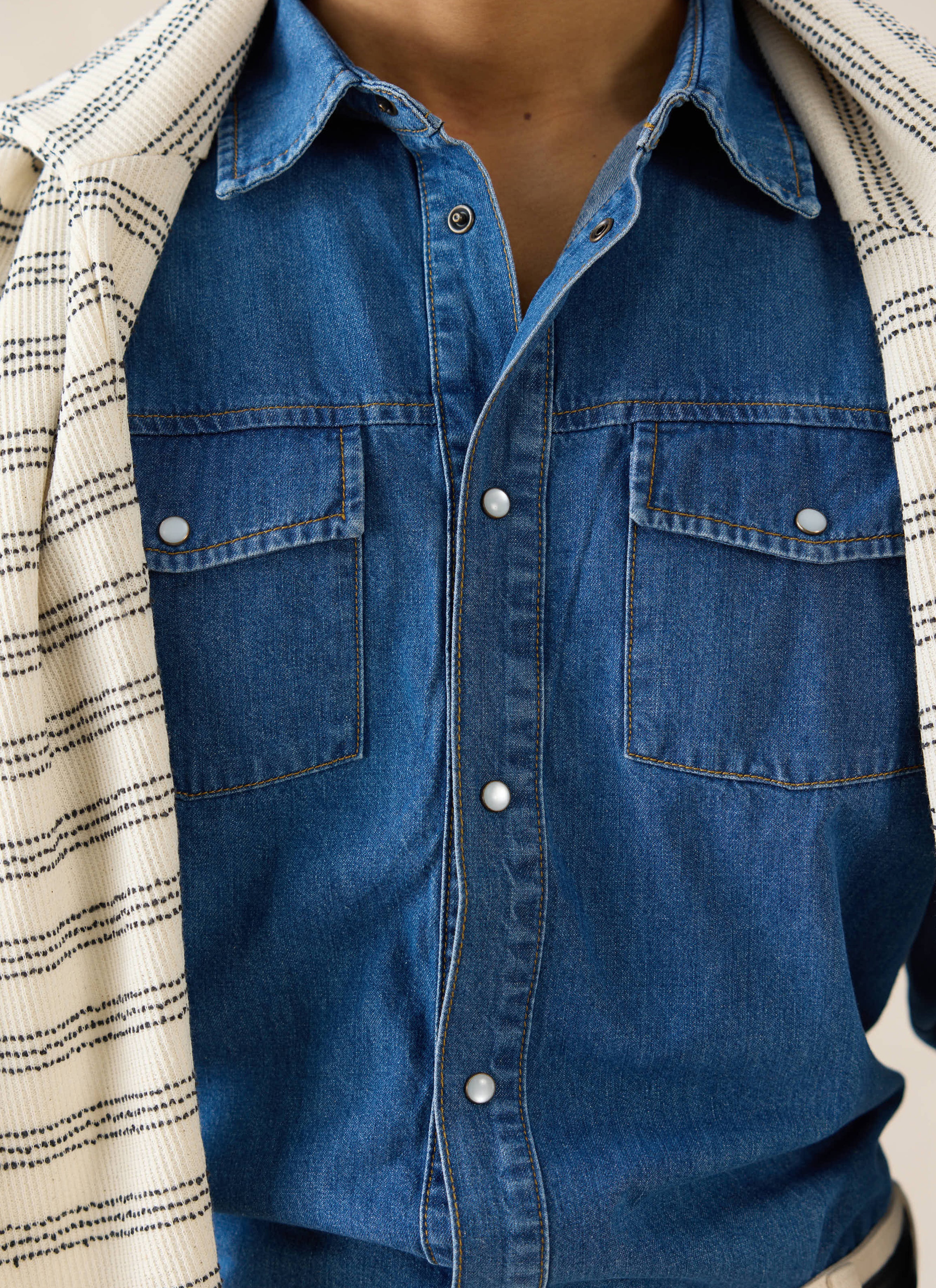 Mid wash blue Percival denim western shirt featuring vintage-inspired pearl snap buttons and twin chest pockets.