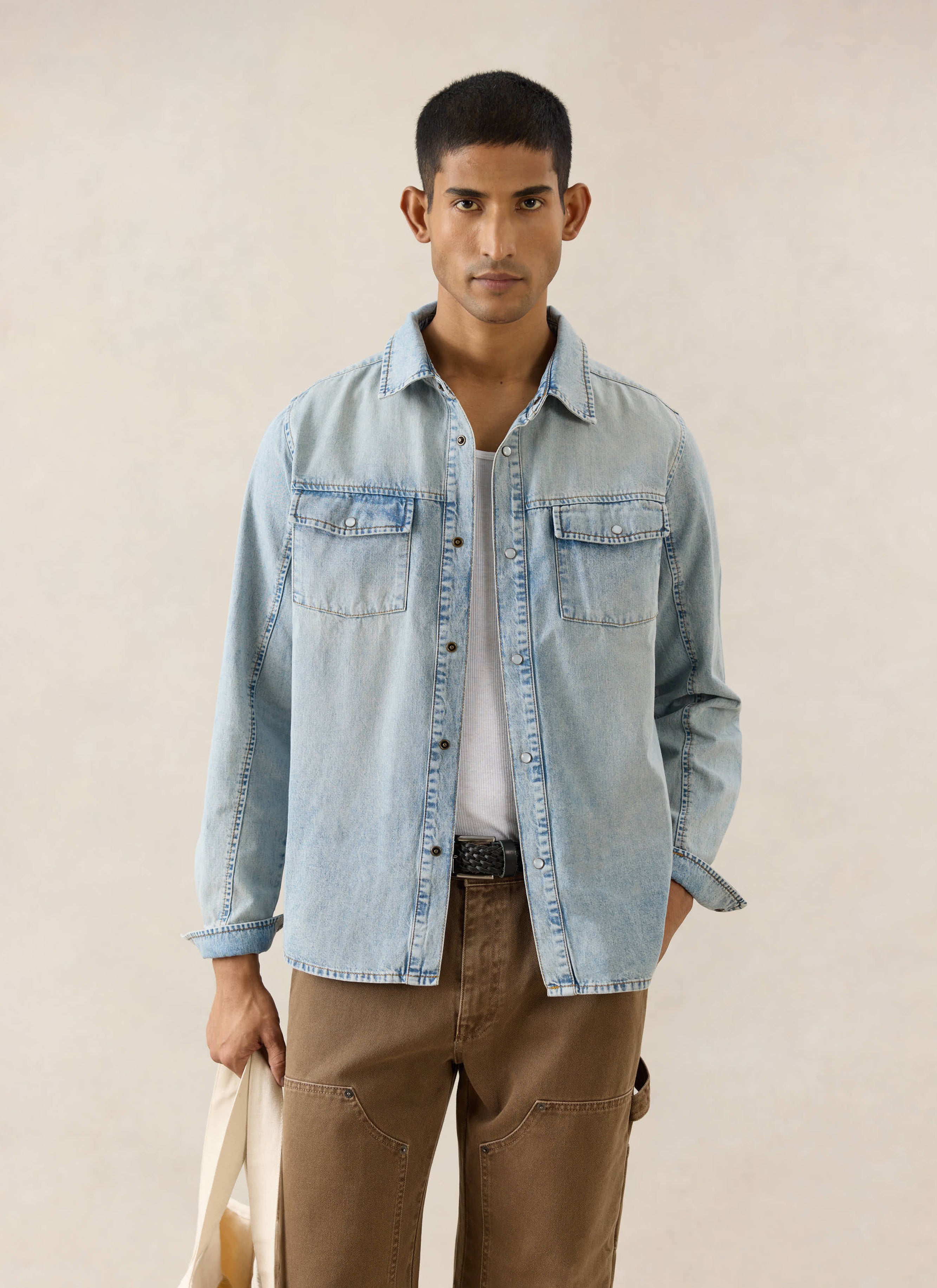 Percival stone wash denim Western shirt with pearl buttons, styled over a white vest and brown carpenter trousers.