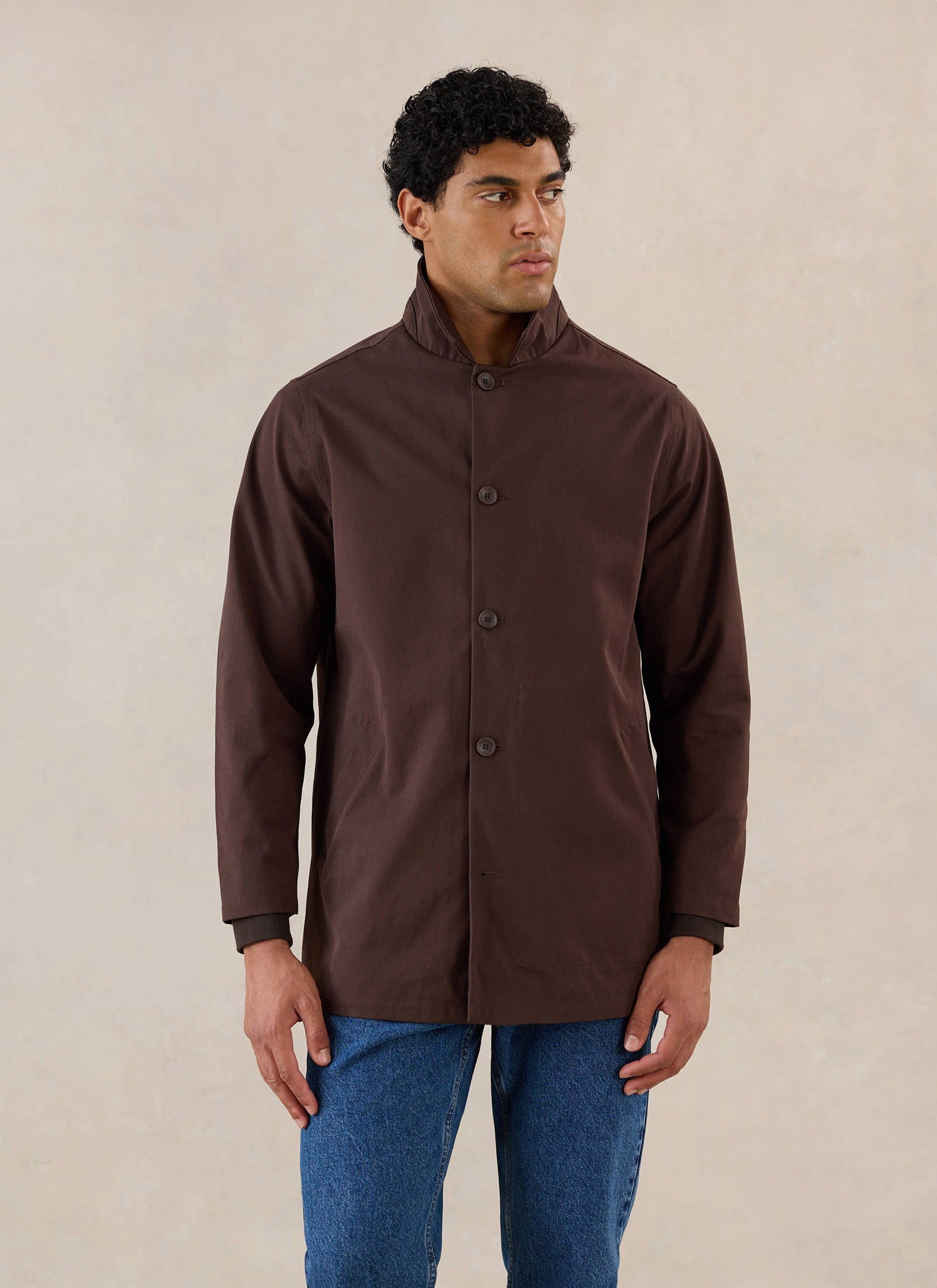 A model wears the Espresso Brown Percival waterproof Sherlock Short Trench coat with button fastening.