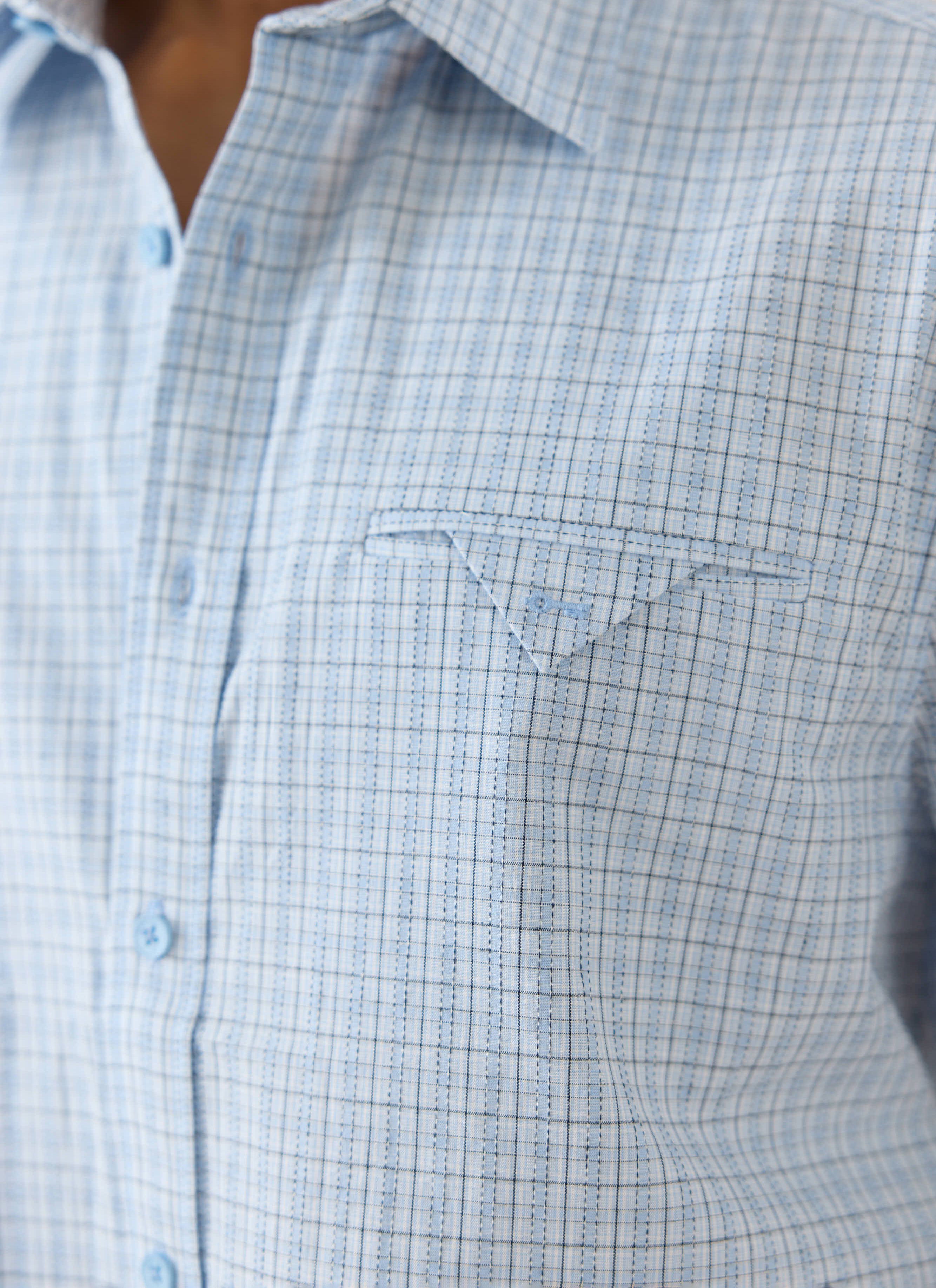 The Percival Hinsley shirt in blue check cotton, featuring a boxy fit and distinctive pocket detail with embroidered key.