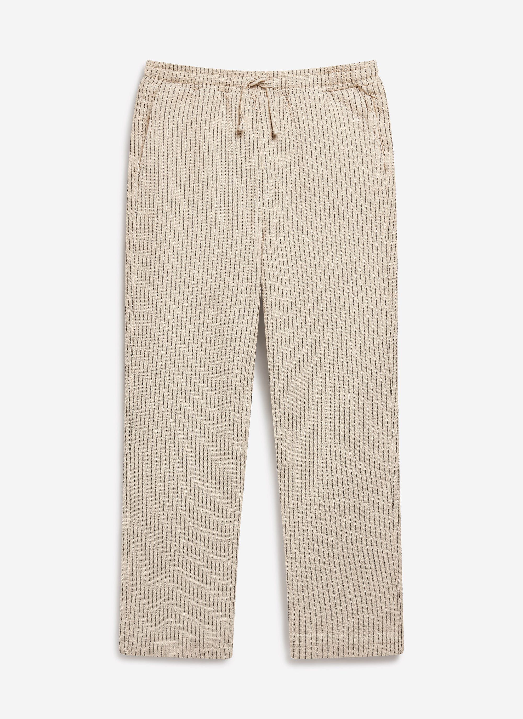 The Percival Sorrento Linen Trousers in ecru, shot flat to showcase the pinstripe pattern and relaxed, drawstring waist fit.