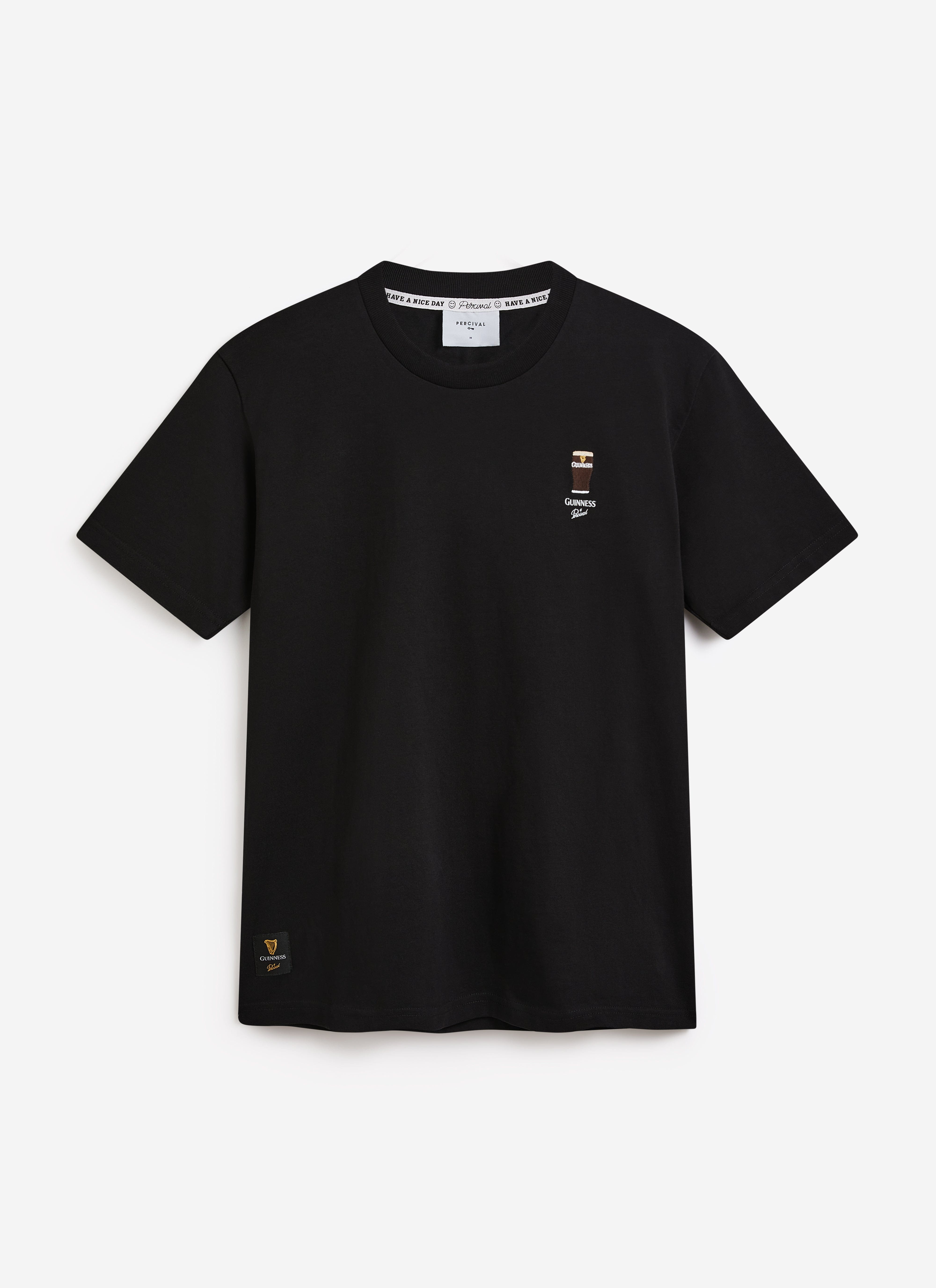 The Percival x Guinness Stout T-shirt in black, shot flat to showcase the detailed stout pint embroidery on the chest.