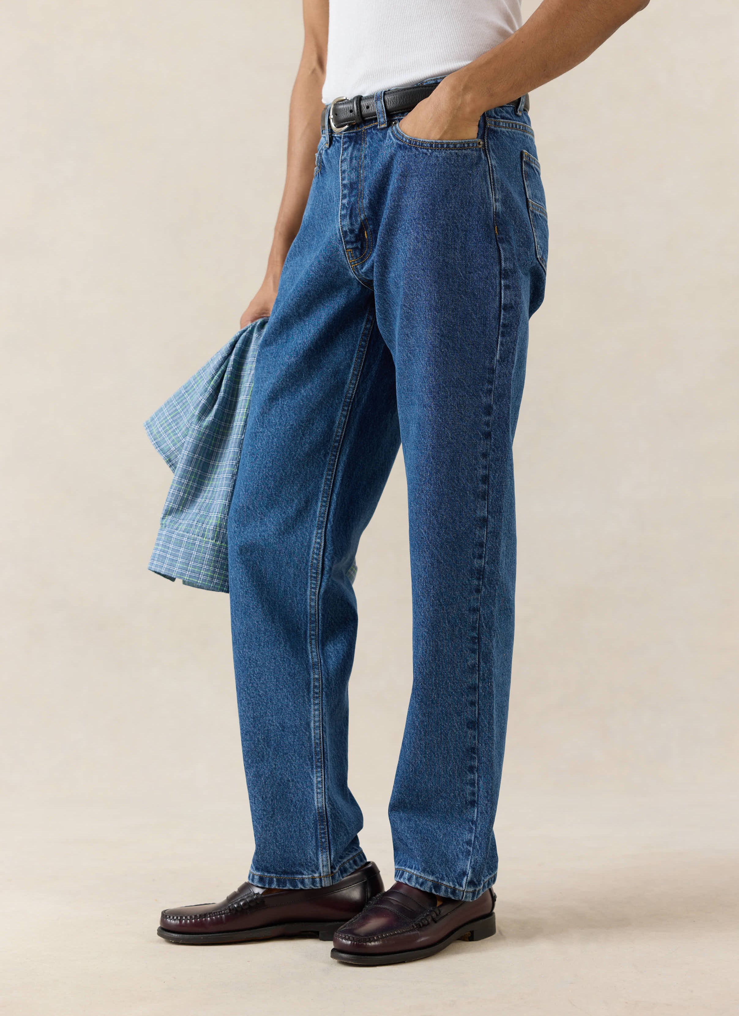 Mid wash blue Percival Heritage Denim Jeans, a structured 14oz cotton straight leg style paired with leather loafers.