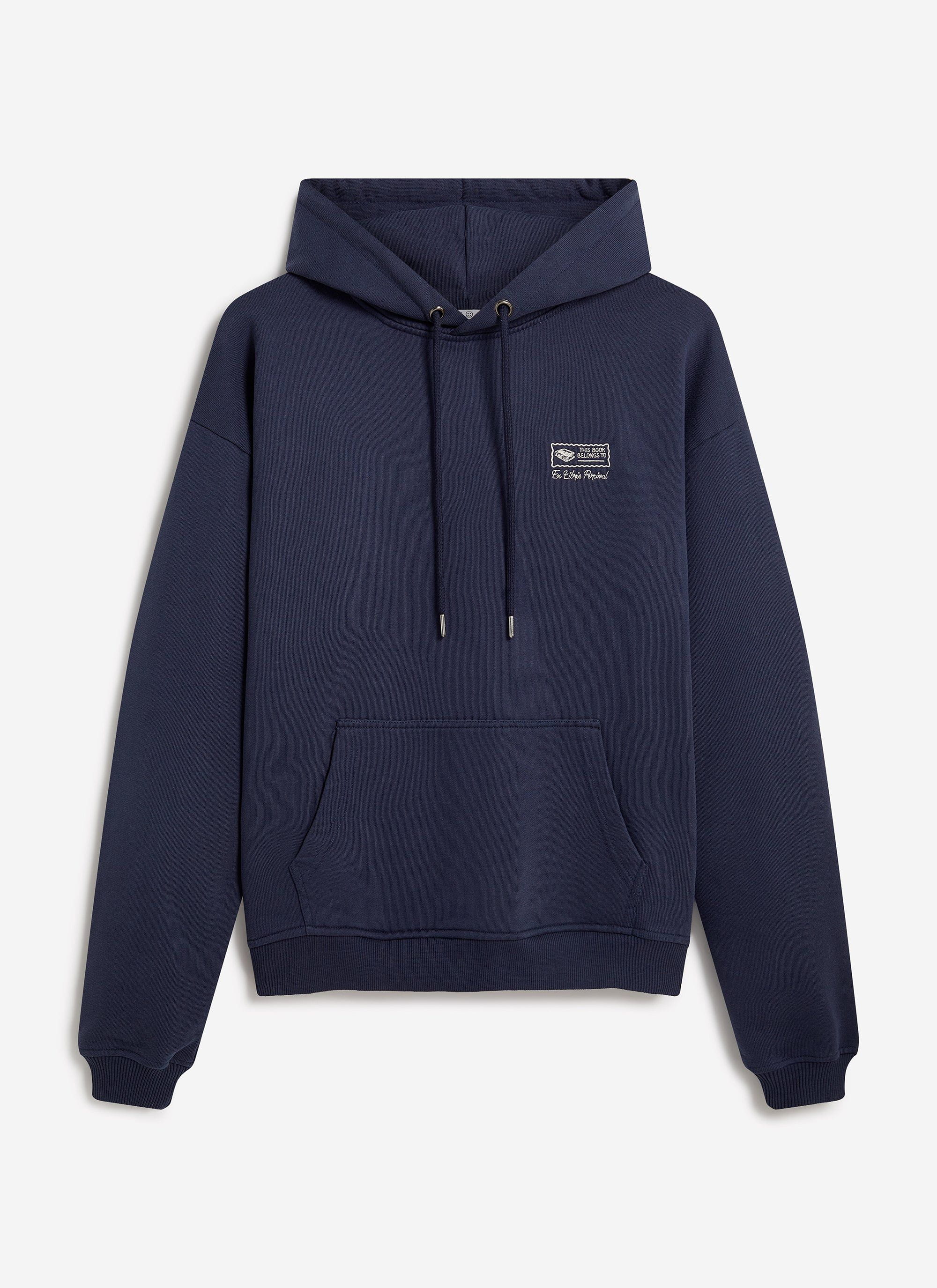 A studio shot of the Percival 'This Book Belongs To' hoodie in navy cotton, laid flat to display its chest embroidery.