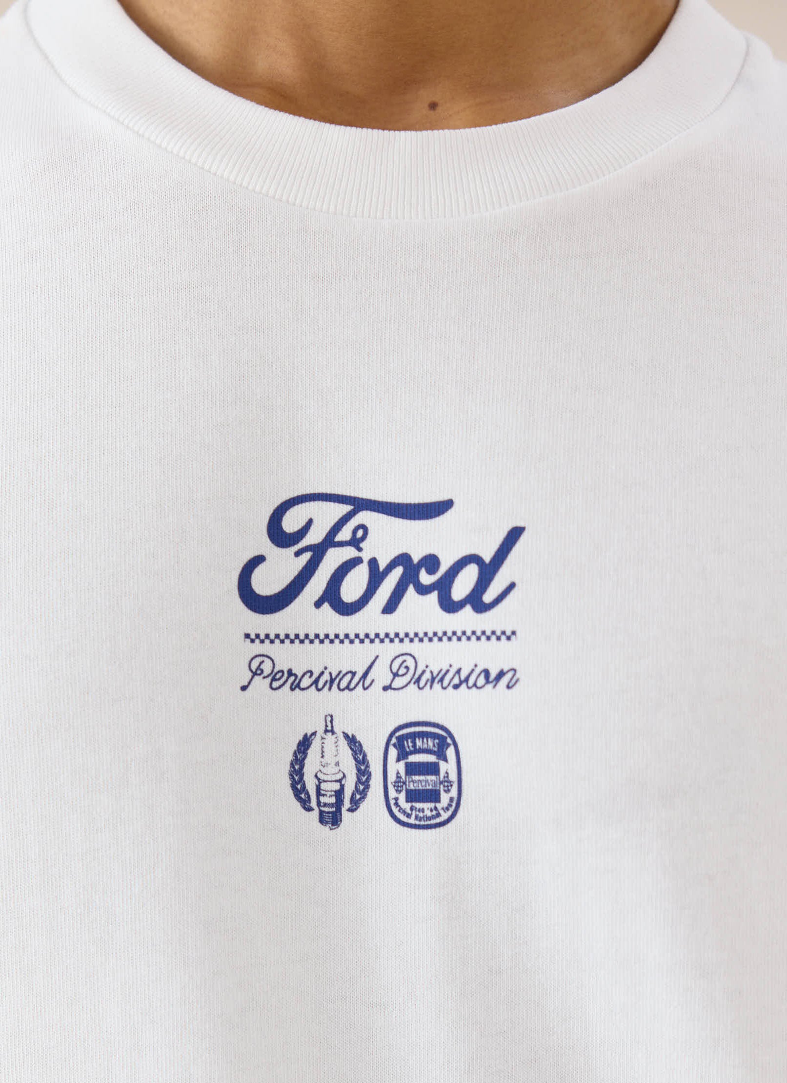A close-up of the blue racing graphic on the white Ford x Percival organic cotton long sleeve t-shirt.
