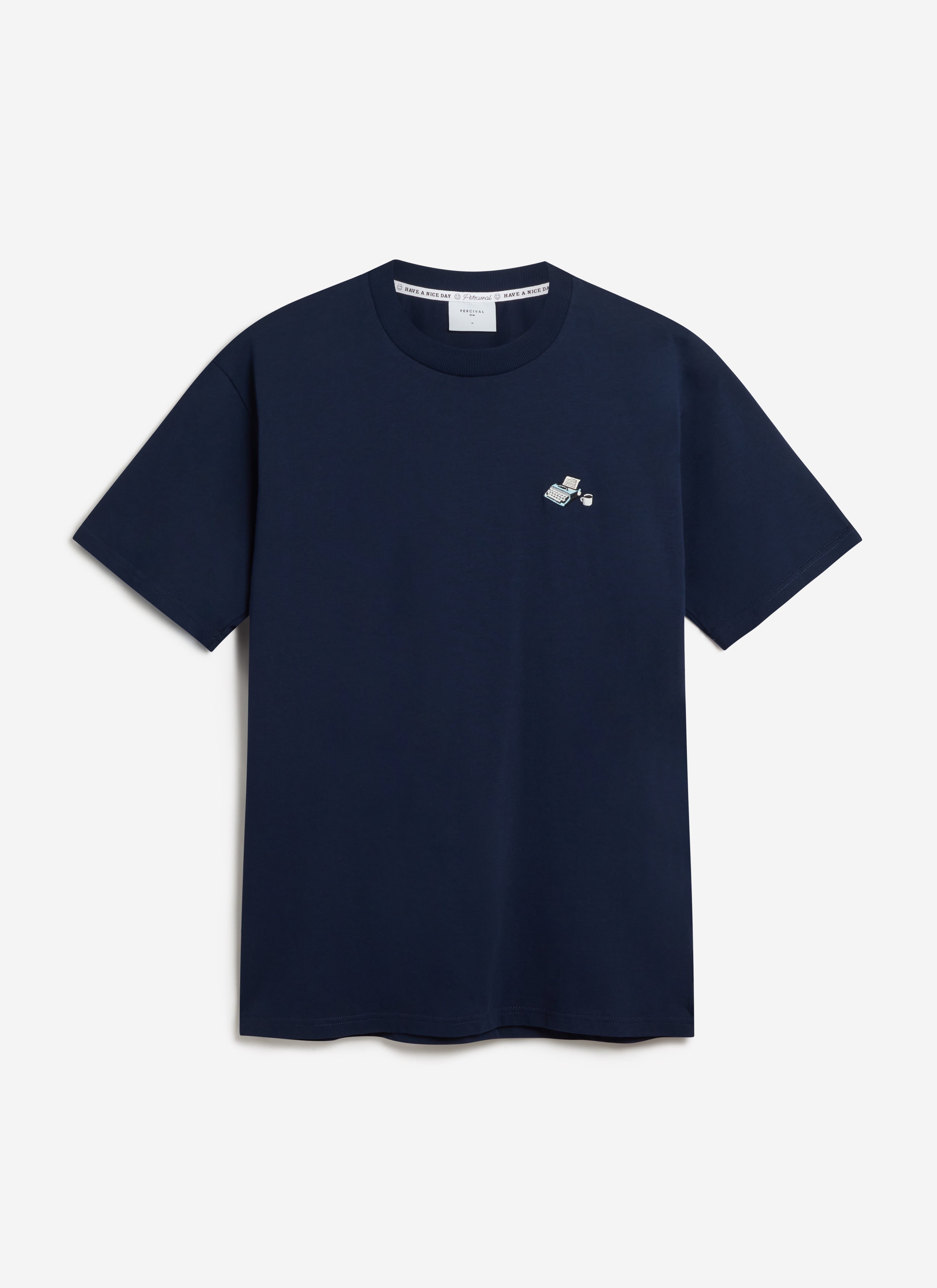 A flat lay of the navy Typewriter Embroidered T Shirt by Percival, showing the embroidery detail on the chest.