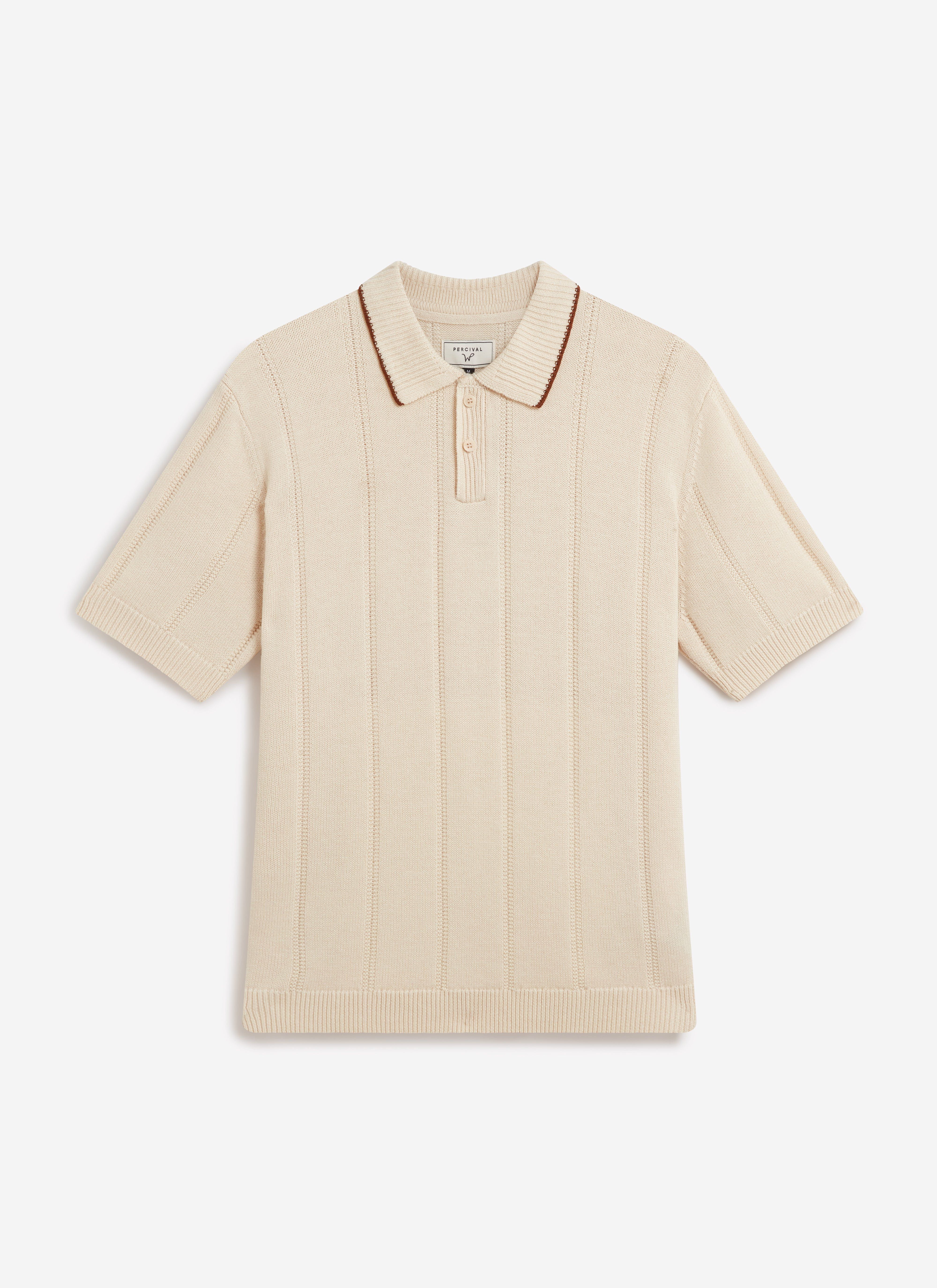 A flat lay of the Percival x Warren knitted polo in ecru, highlighting the vertical stripe texture and brown collar trim.