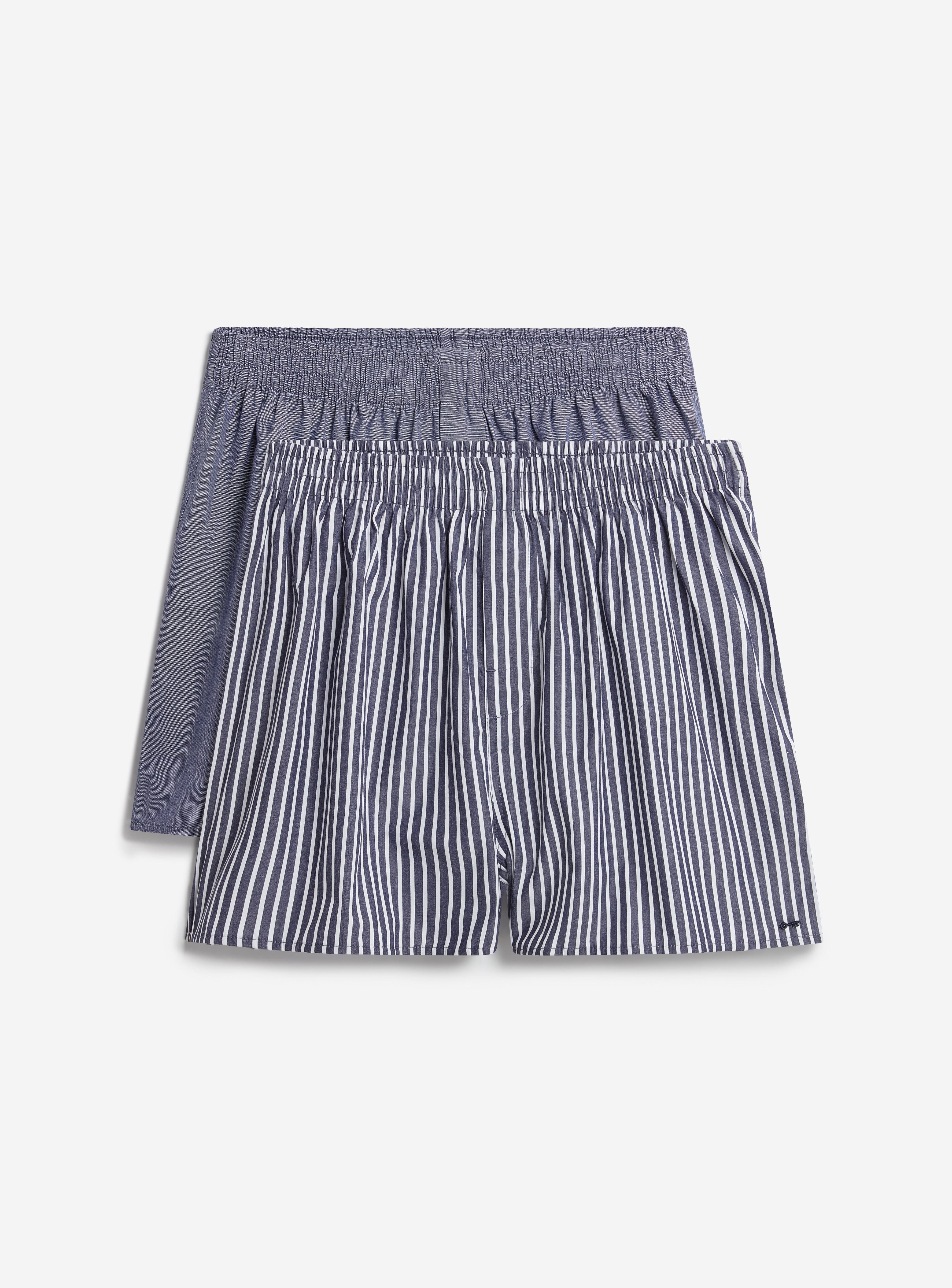A two-pack of Percival cotton boxers, with one plain blue pair and one navy and white striped pair, on a white background.