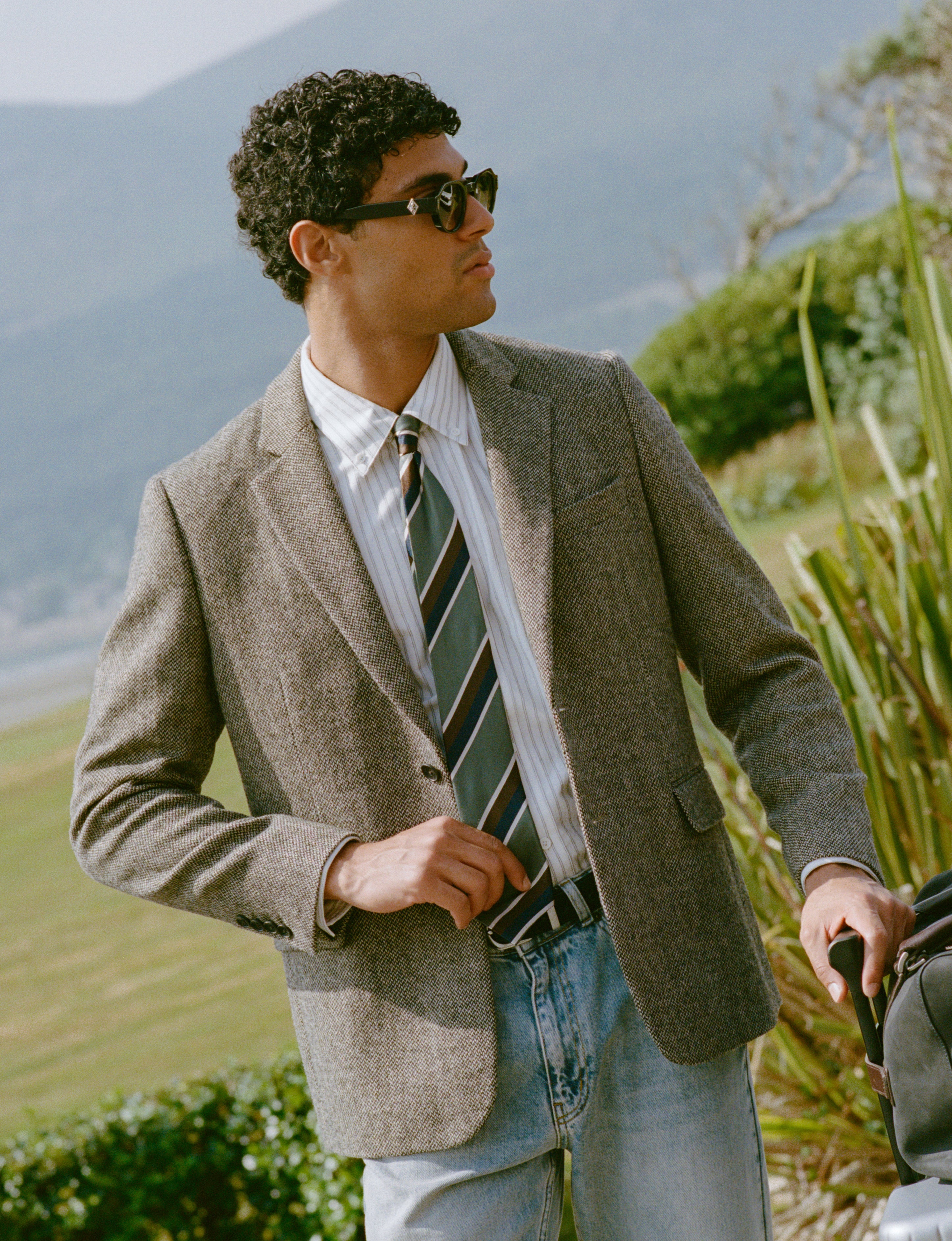 A model wears the Percival Tailored Blazer Birdseye Wool Grey and Percival Stripe Tie Silk Multi.