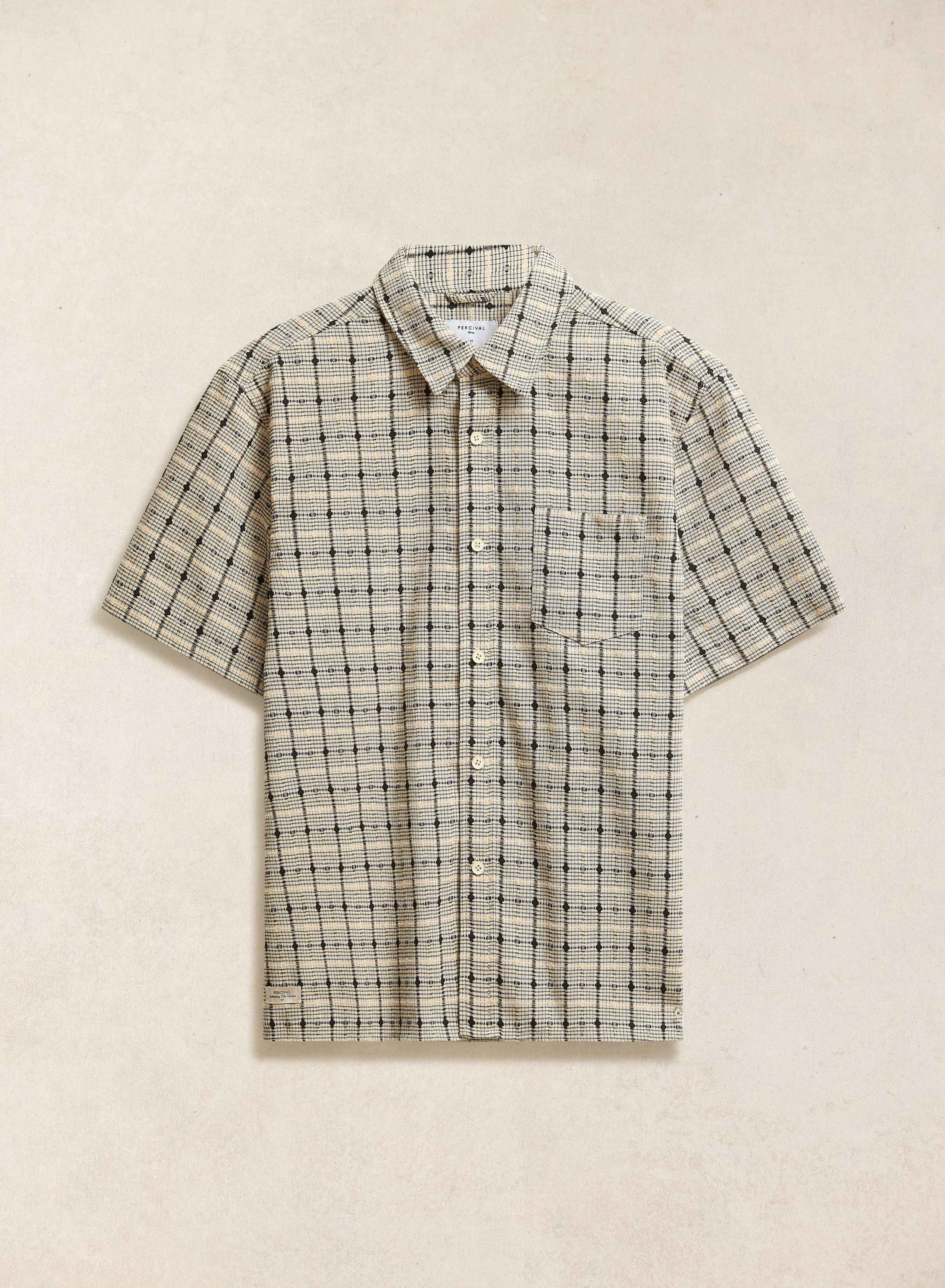 The Percival Bayley textured short-sleeve check shirt in cream 100% cotton, featuring a geometric plaid pattern.