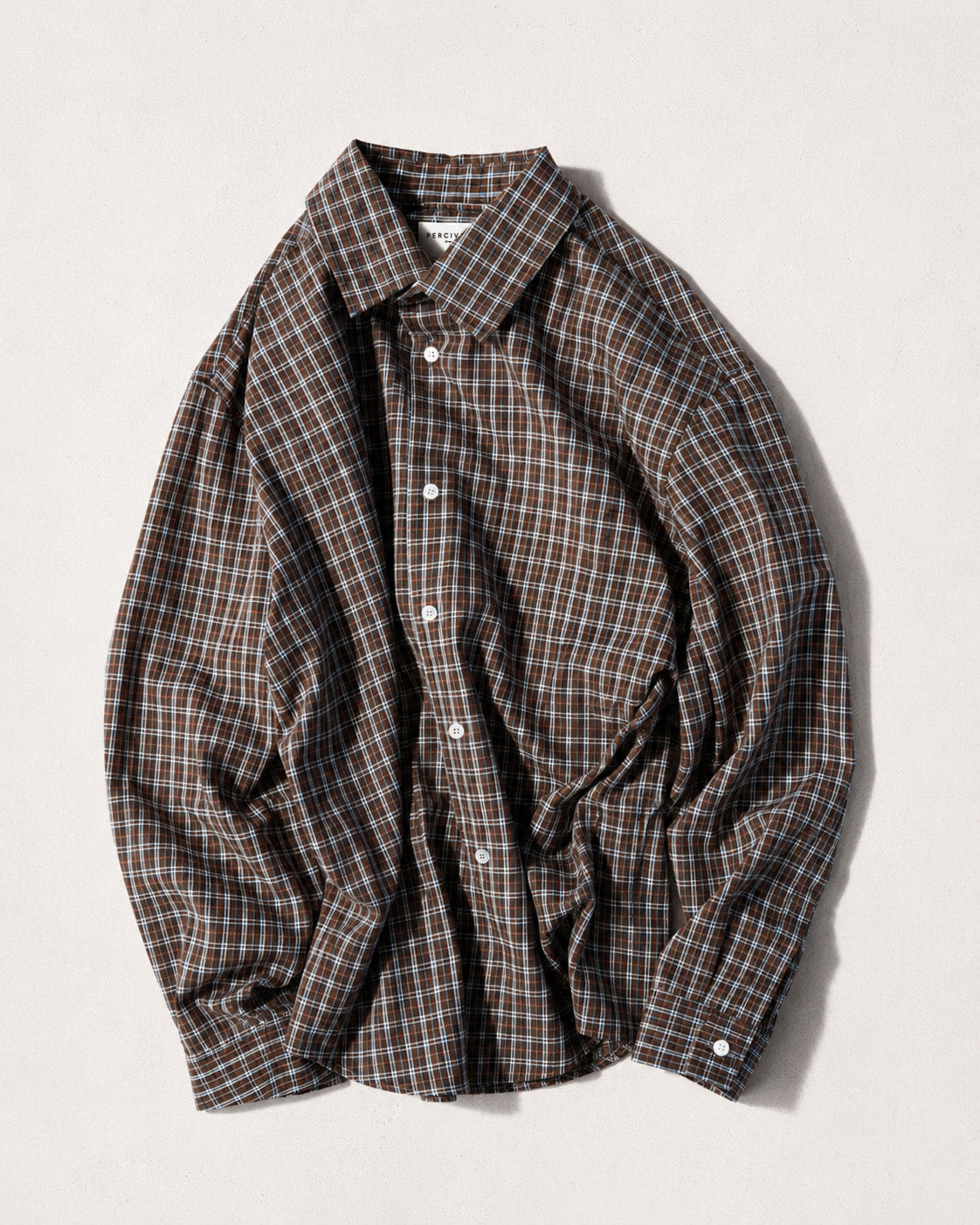 Percival Hinsley brown checked boxy shirt in 100% cotton with white buttons and a point collar, shown laid flat.