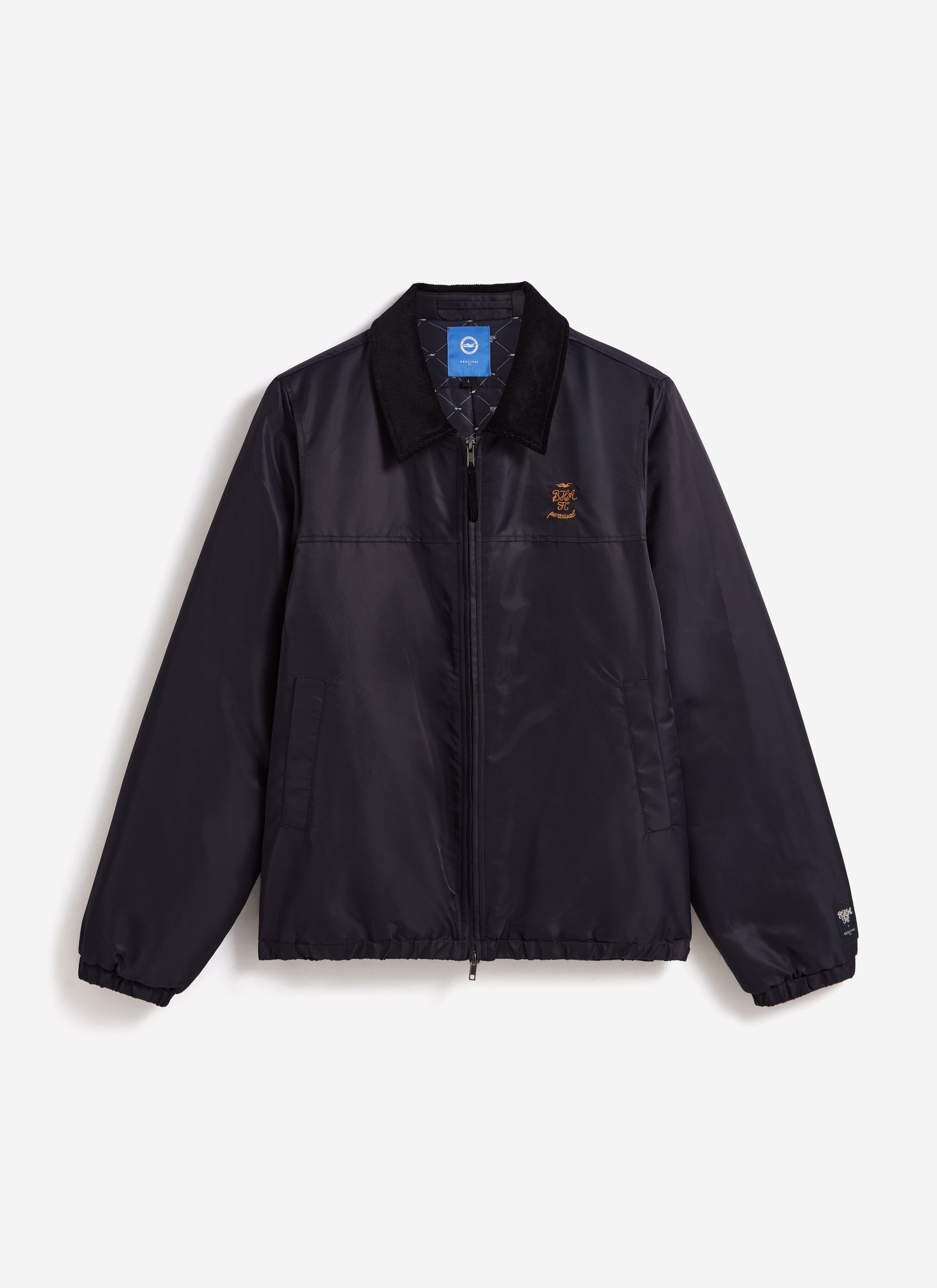 Front view of the navy Percival x Brighton & Hove Albion F.C. Coach Jacket, showing the cord collar and chest embroidery.