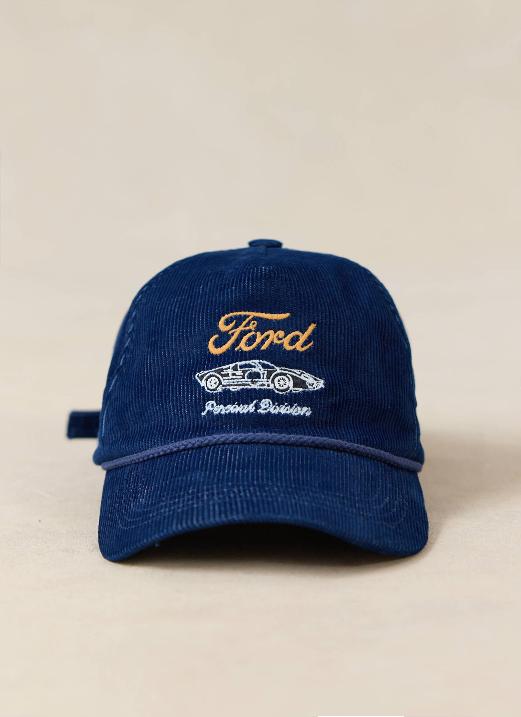 Navy cord soft trucker cap by Ford x Percival featuring embroidered racing graphics and a contrast blue rope trim.