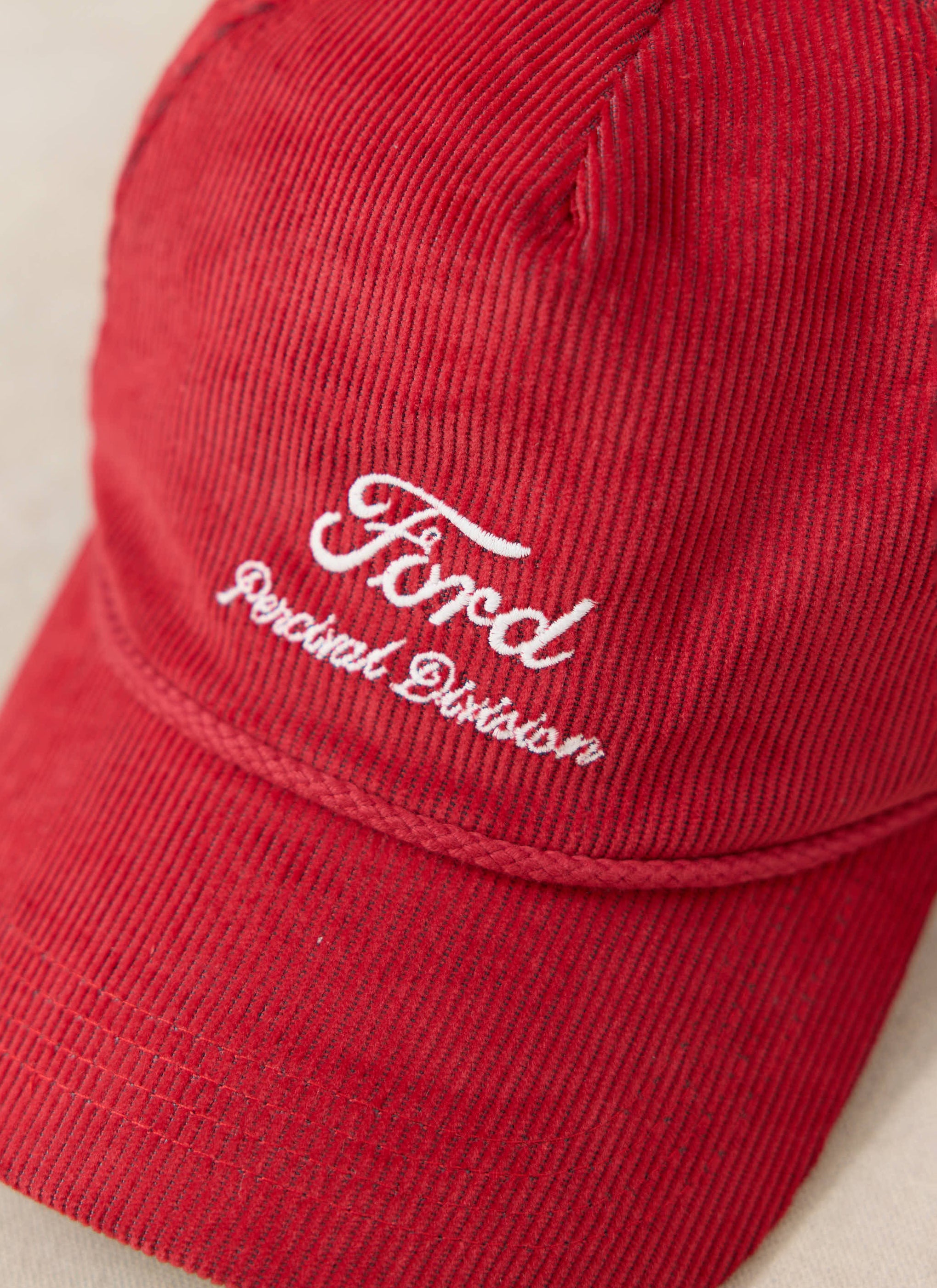 Red corduroy Ford x Percival soft trucker cap featuring white 'Ford Percival Division' embroidery.