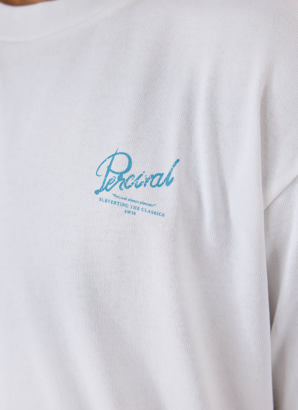 Close-up of the white Percival organic cotton t-shirt showing the blue chest graphic detail.