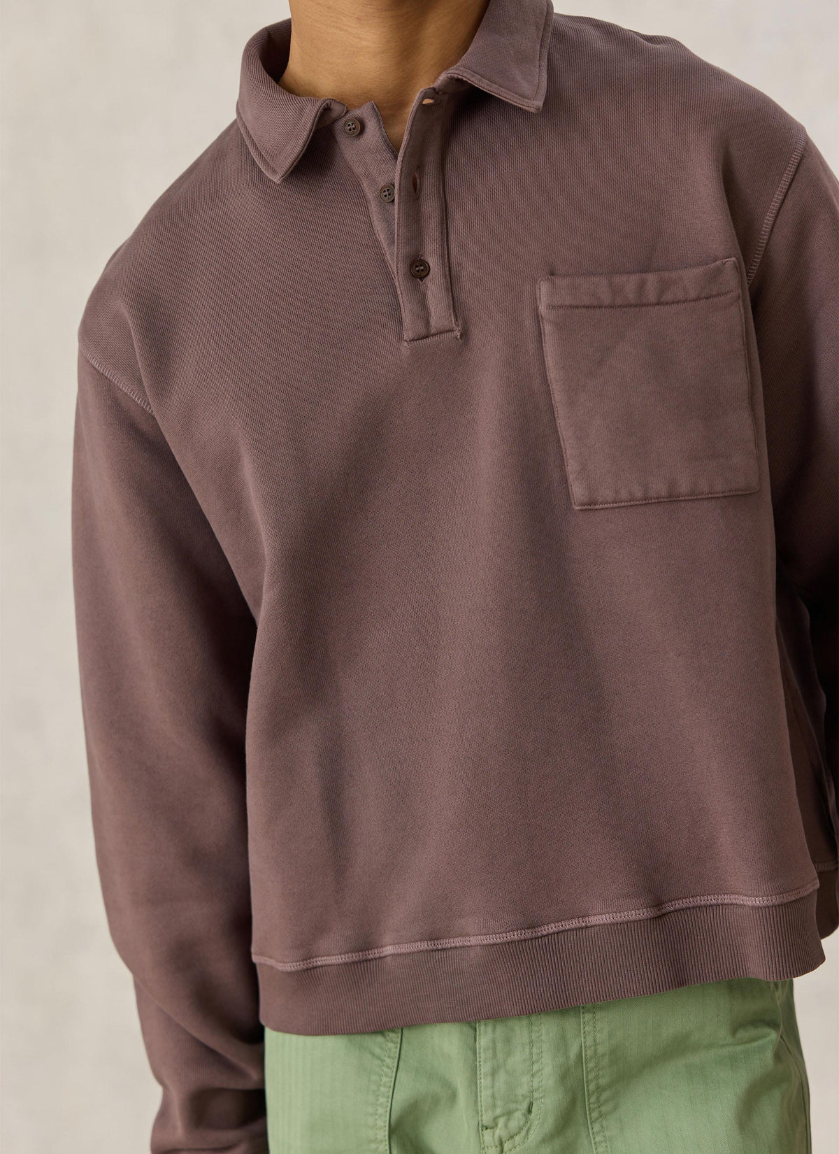 Close-up of the Percival Dudley brown cotton popover sweatshirt, showing the collared neckline, buttons, and chest pocket.