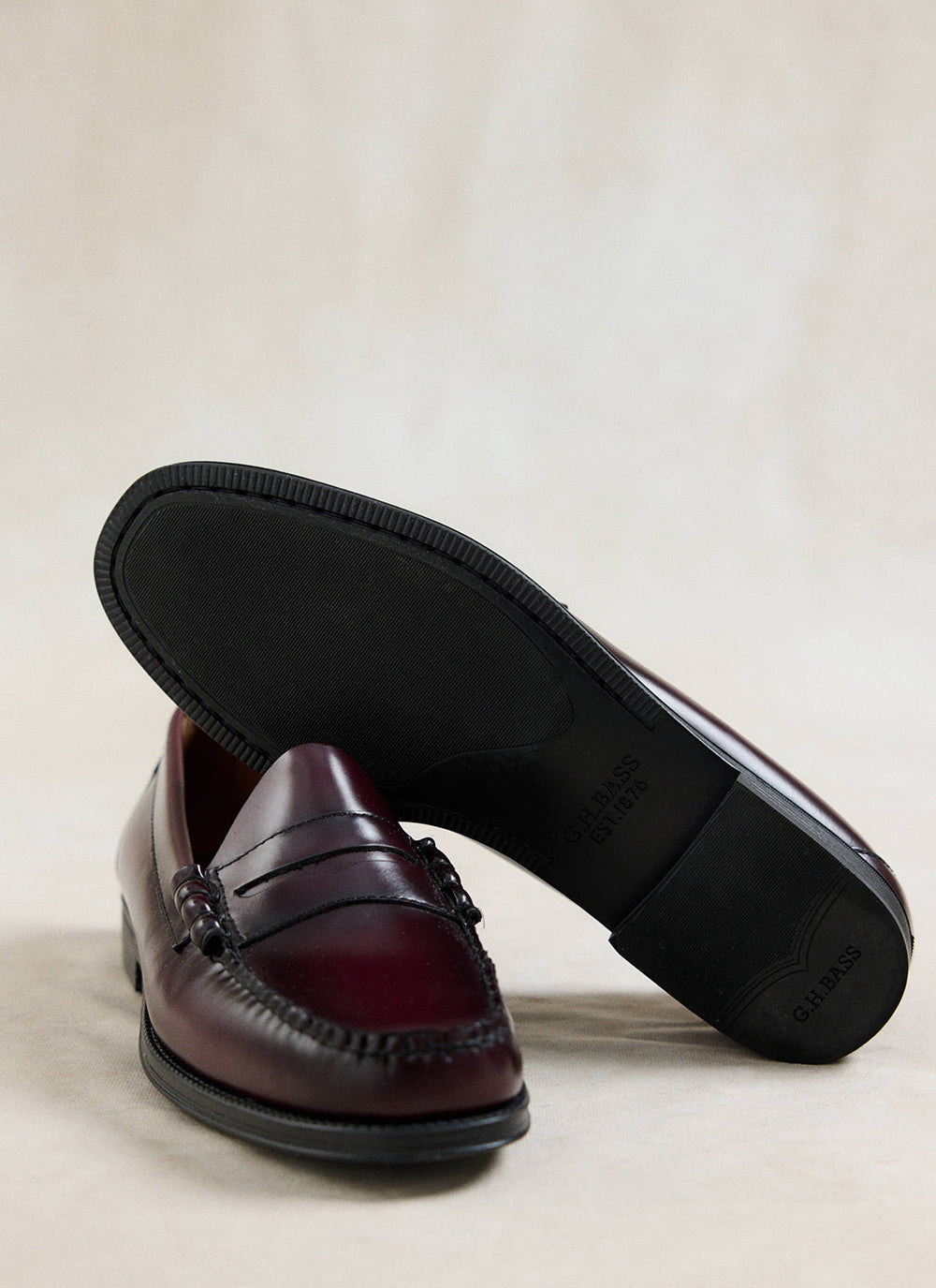 G.H. Bass Easy Weejun Larson penny loafer in wine leather, displaying the textured rubber sole and polished upper.