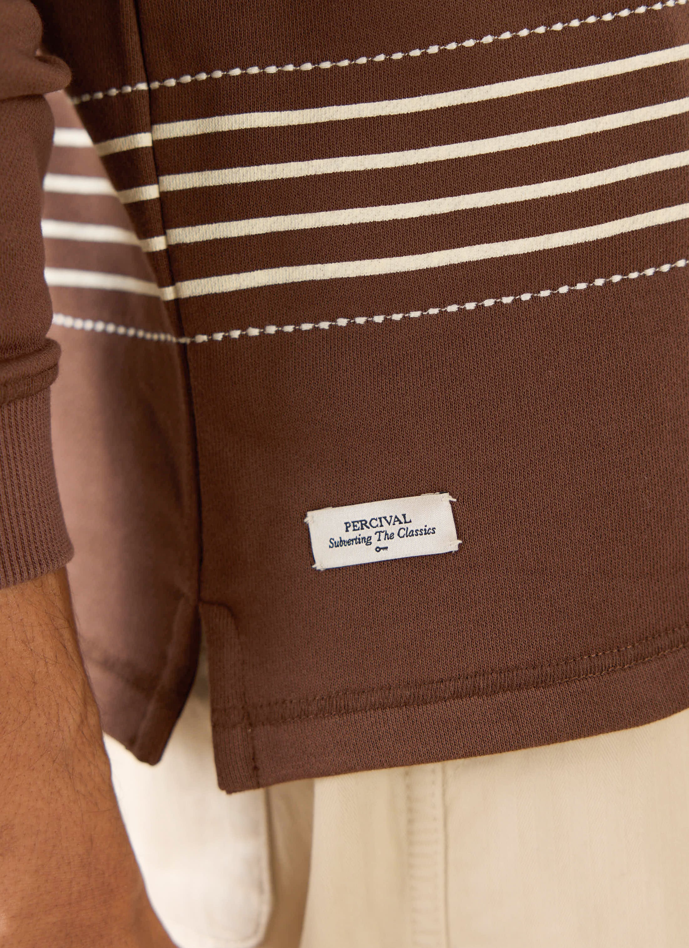 The Percival Editor Striped Rugby Polo in espresso cotton, featuring white horizontal stripes and stab stitching.