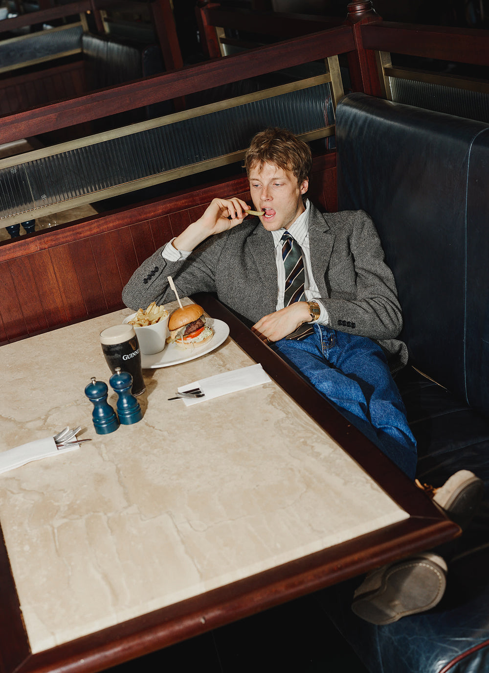 Multi and Percival Fabian Striped Shirt in a restaurant booth.