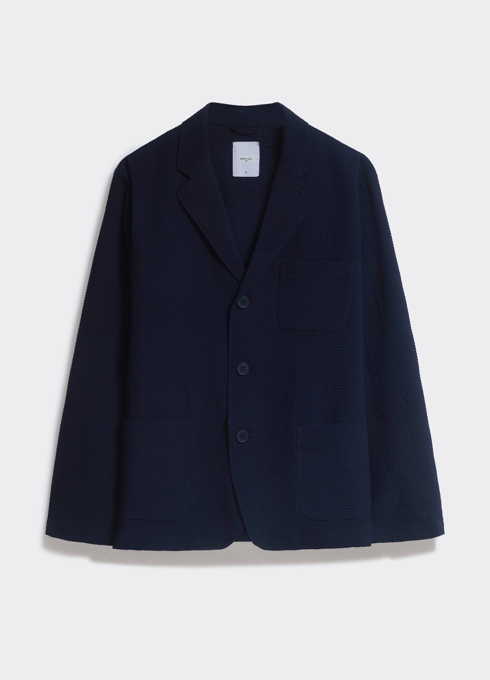 Navy Percival Geno Blazer in textured seersucker with a notch lapel and three buttons, shown against a white background.